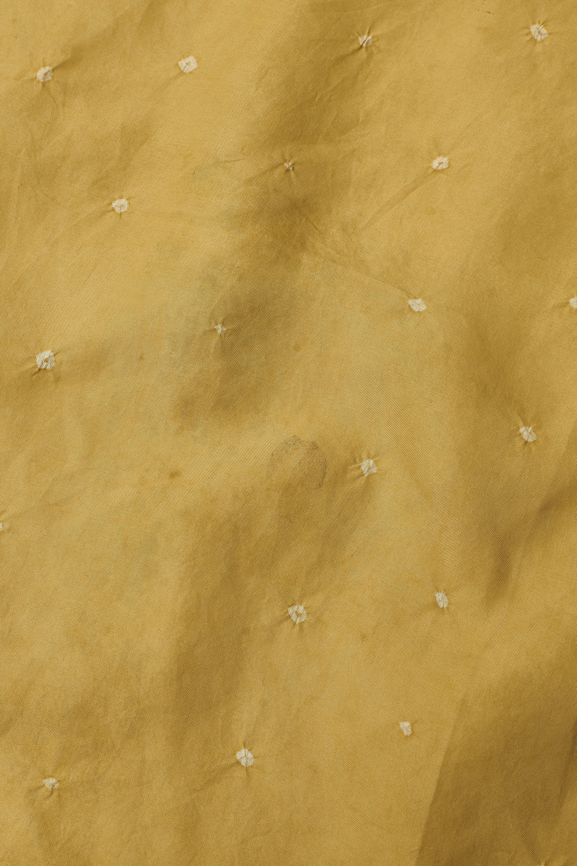 Textured beige fabric with small white floral patterns