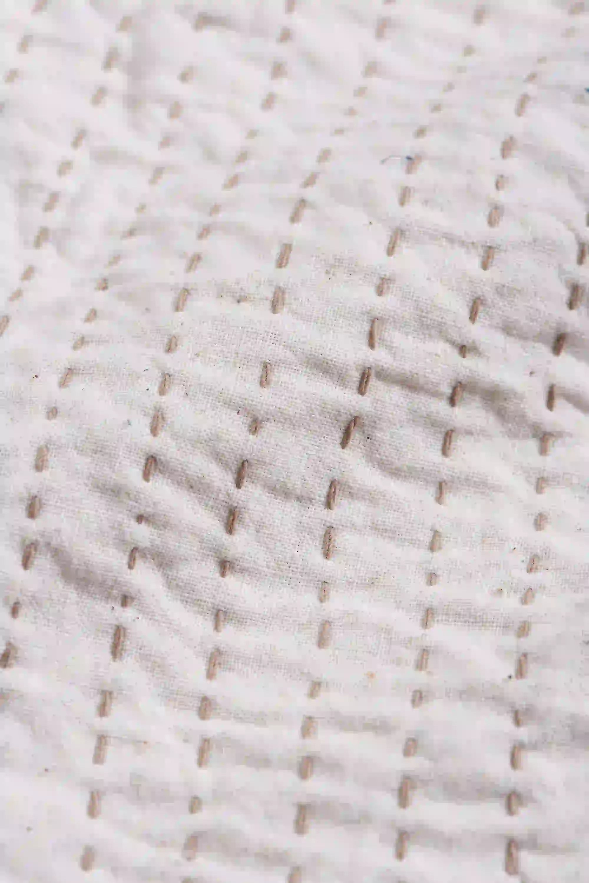 Close-up of textured brown fabric with a subtle pattern