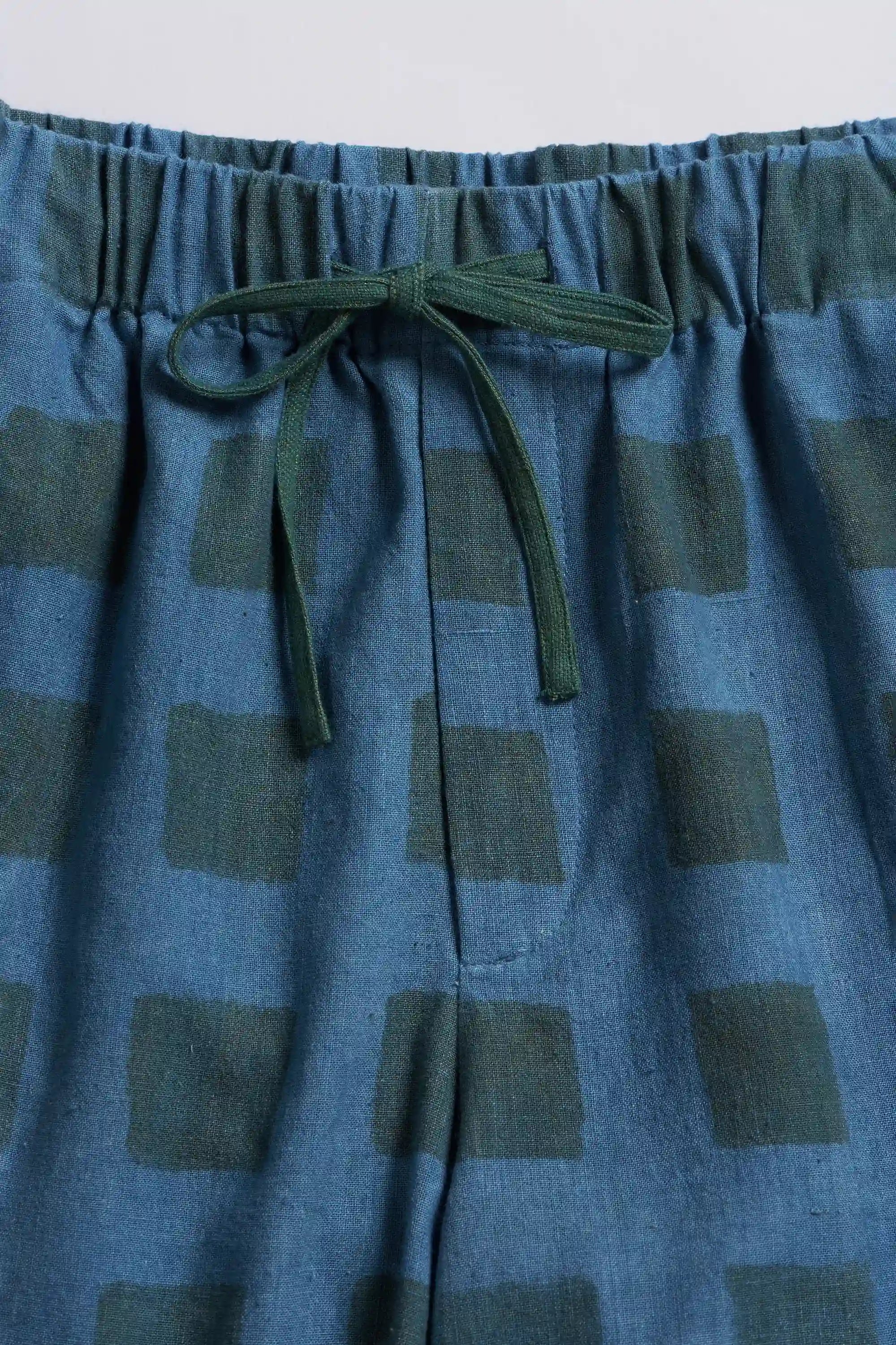 Blue checkered pants with a drawstring waist on a white background