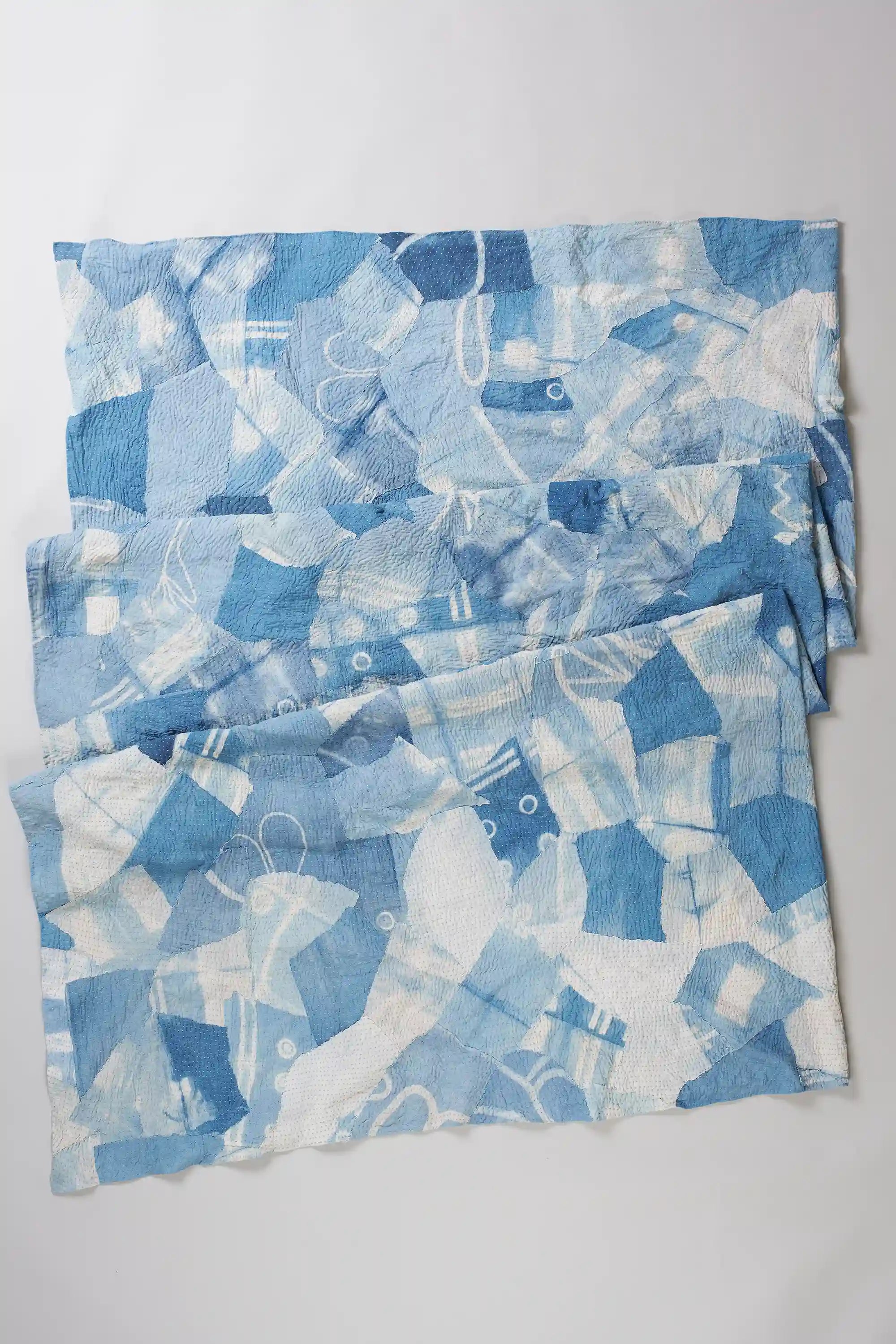 Sky indigo cotton quilt on light grey back ground