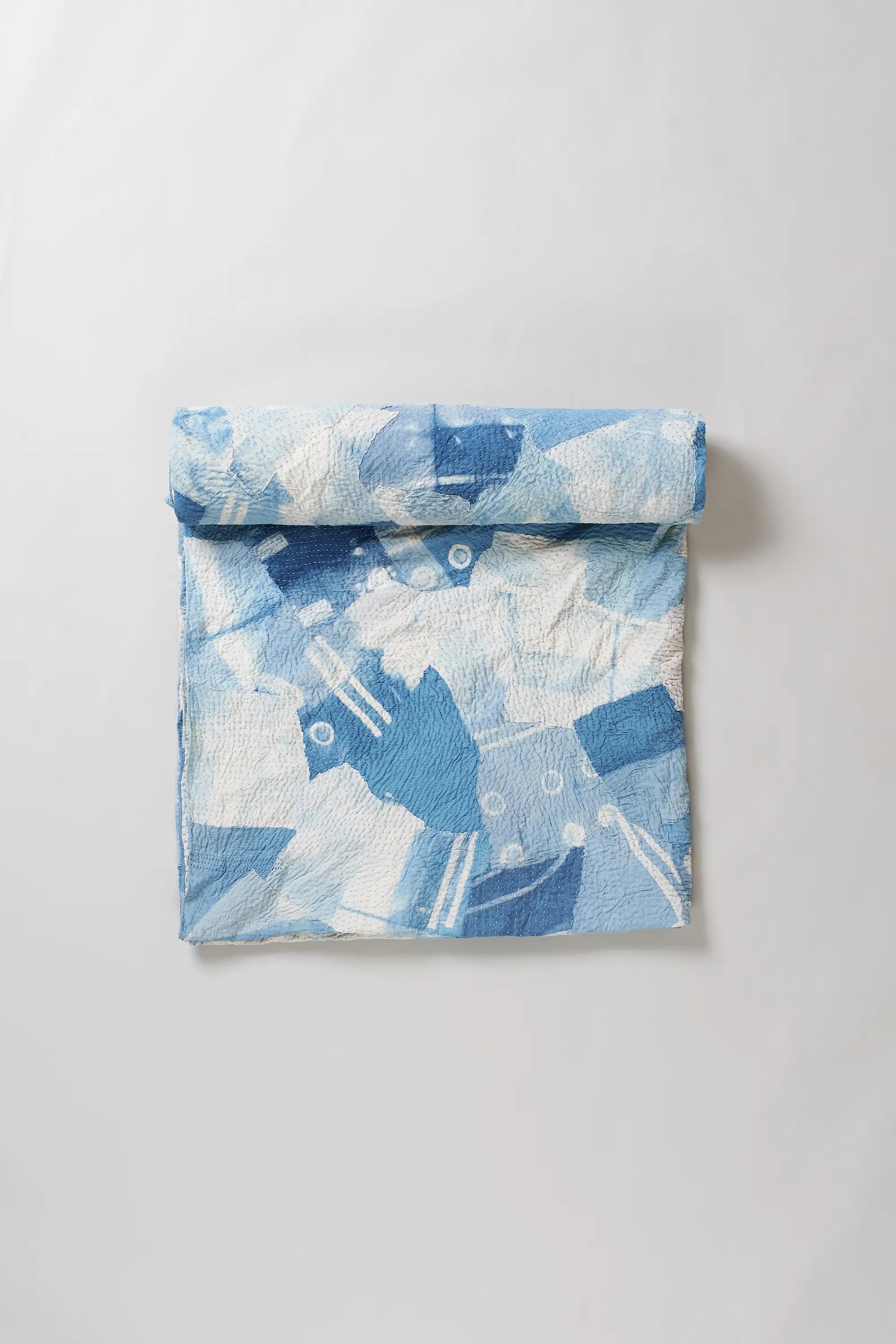 Sky indigo quilt roll on light grey background