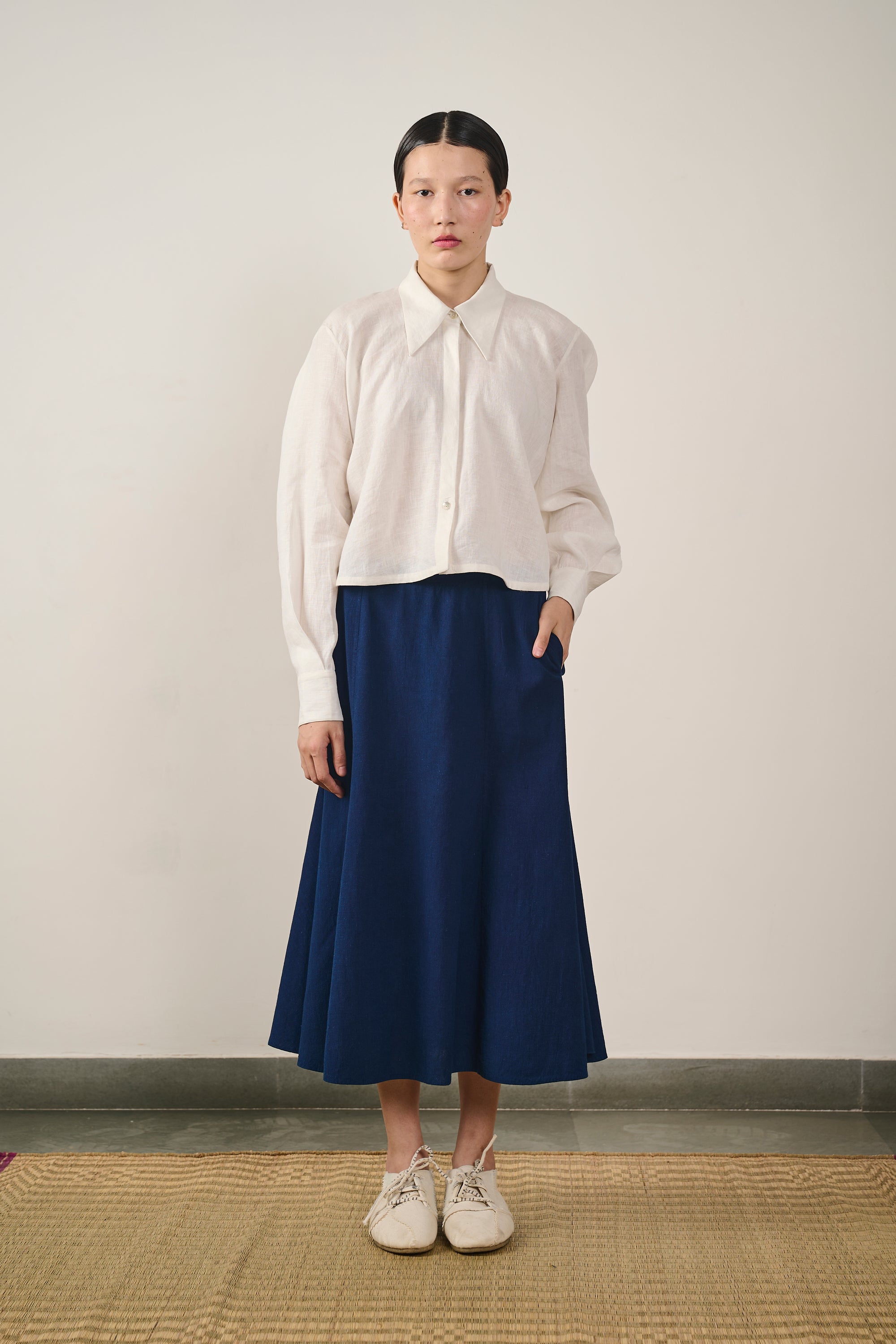 A woman wearing linen ecru cropped shirt