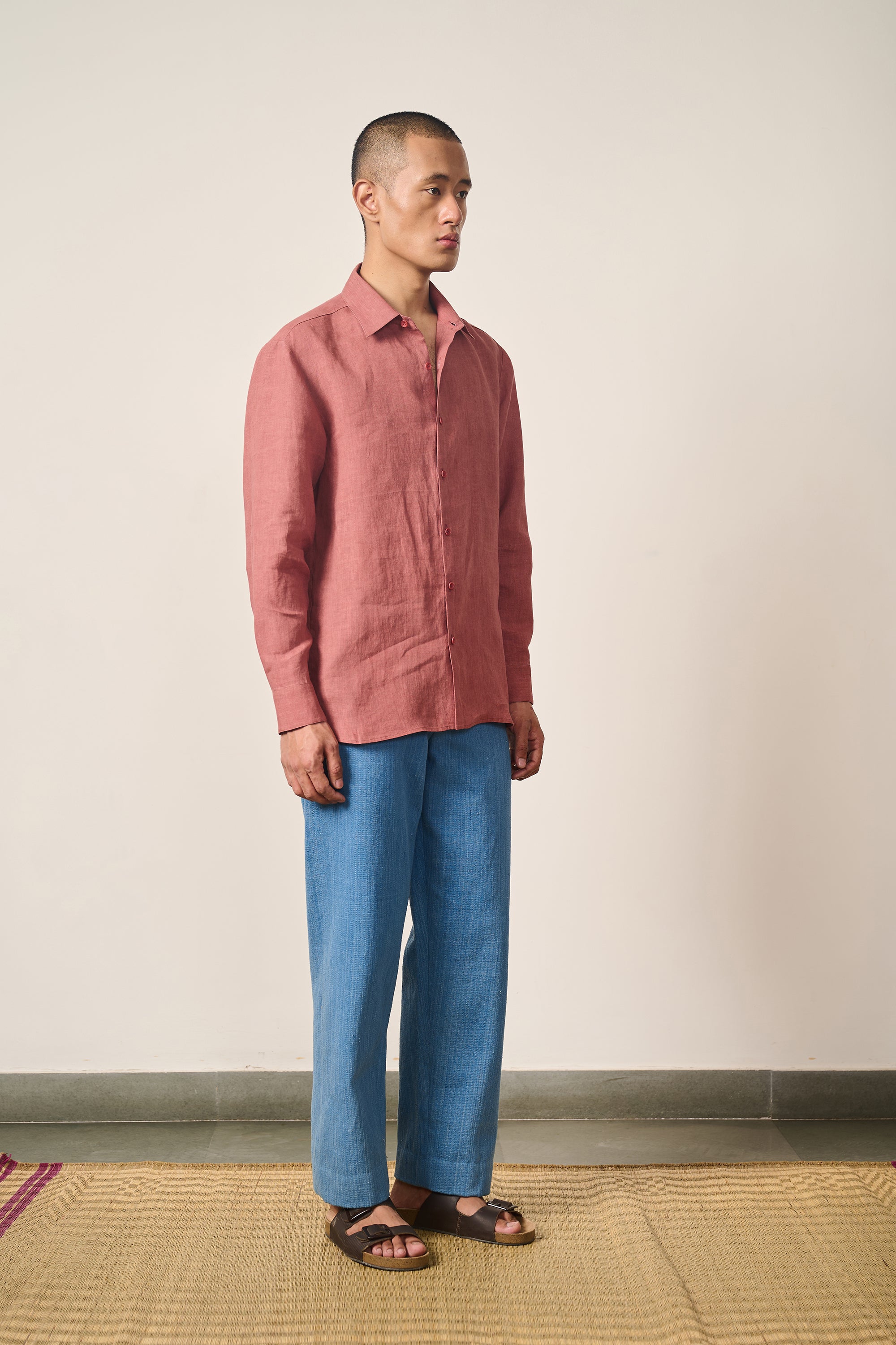 A man wearing linen rouge pink shirt