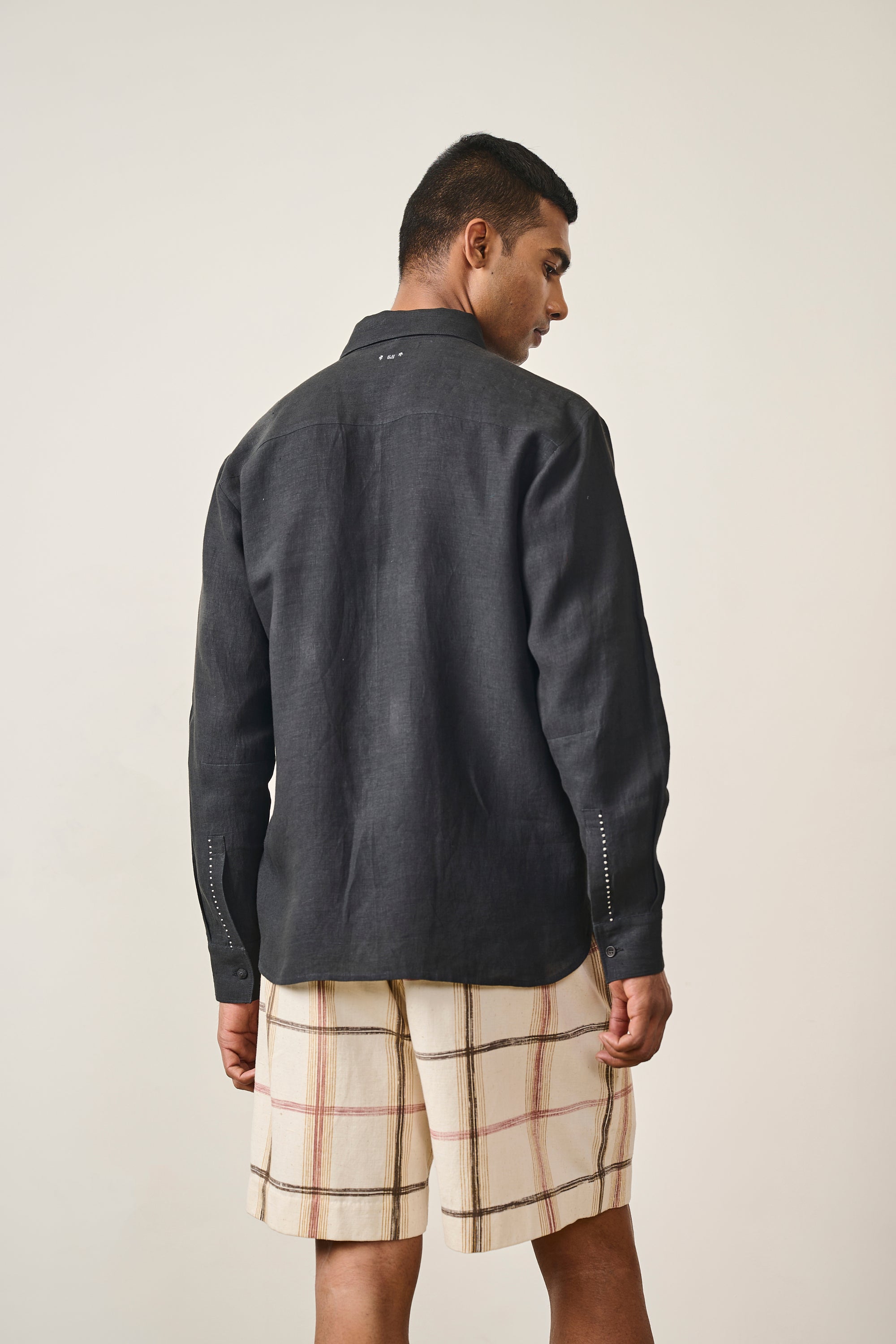 A back shot of a man wearing black shirt