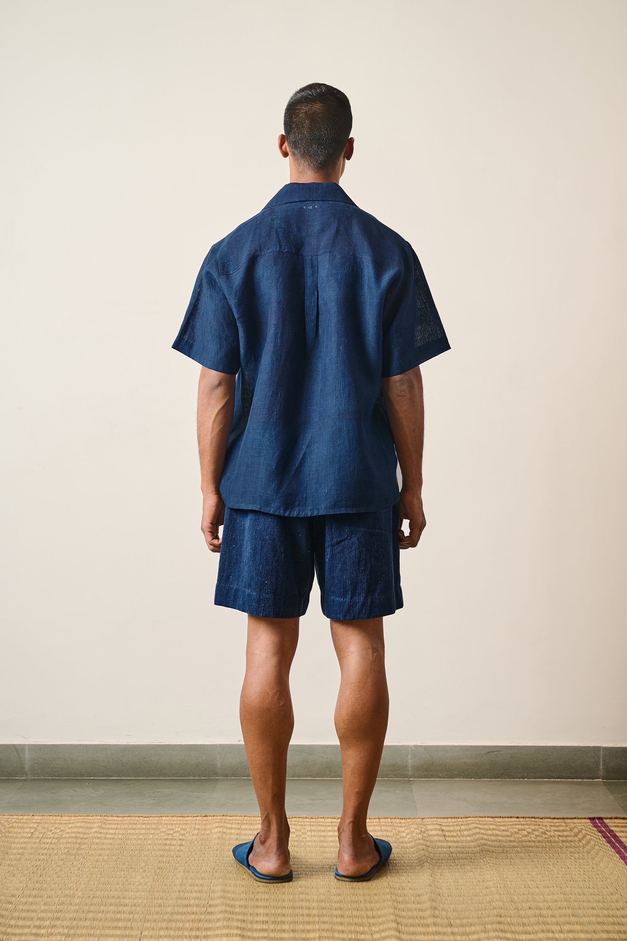 A back shot of a man wearing linen shirt