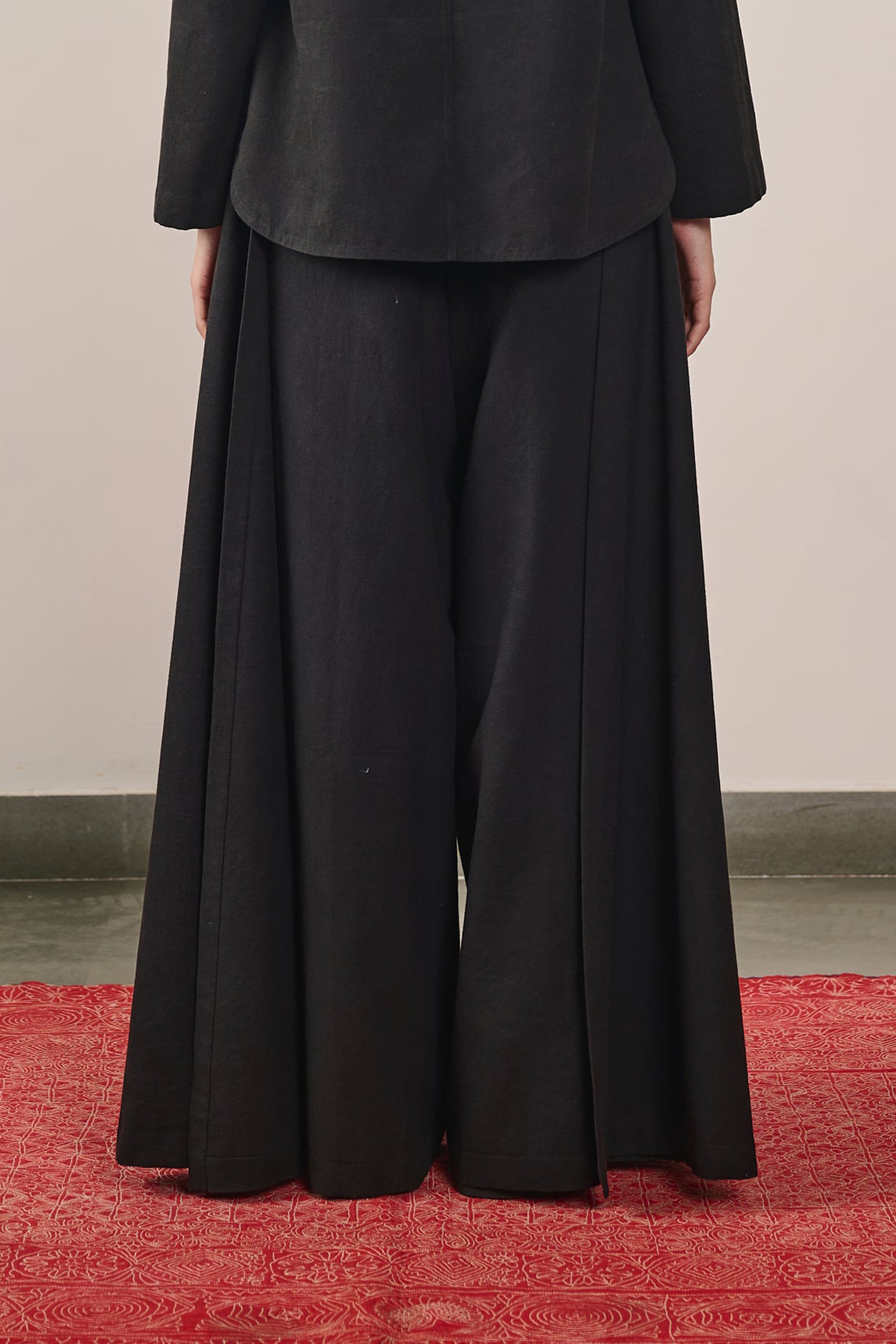A back shot of a woman wearing black pant
