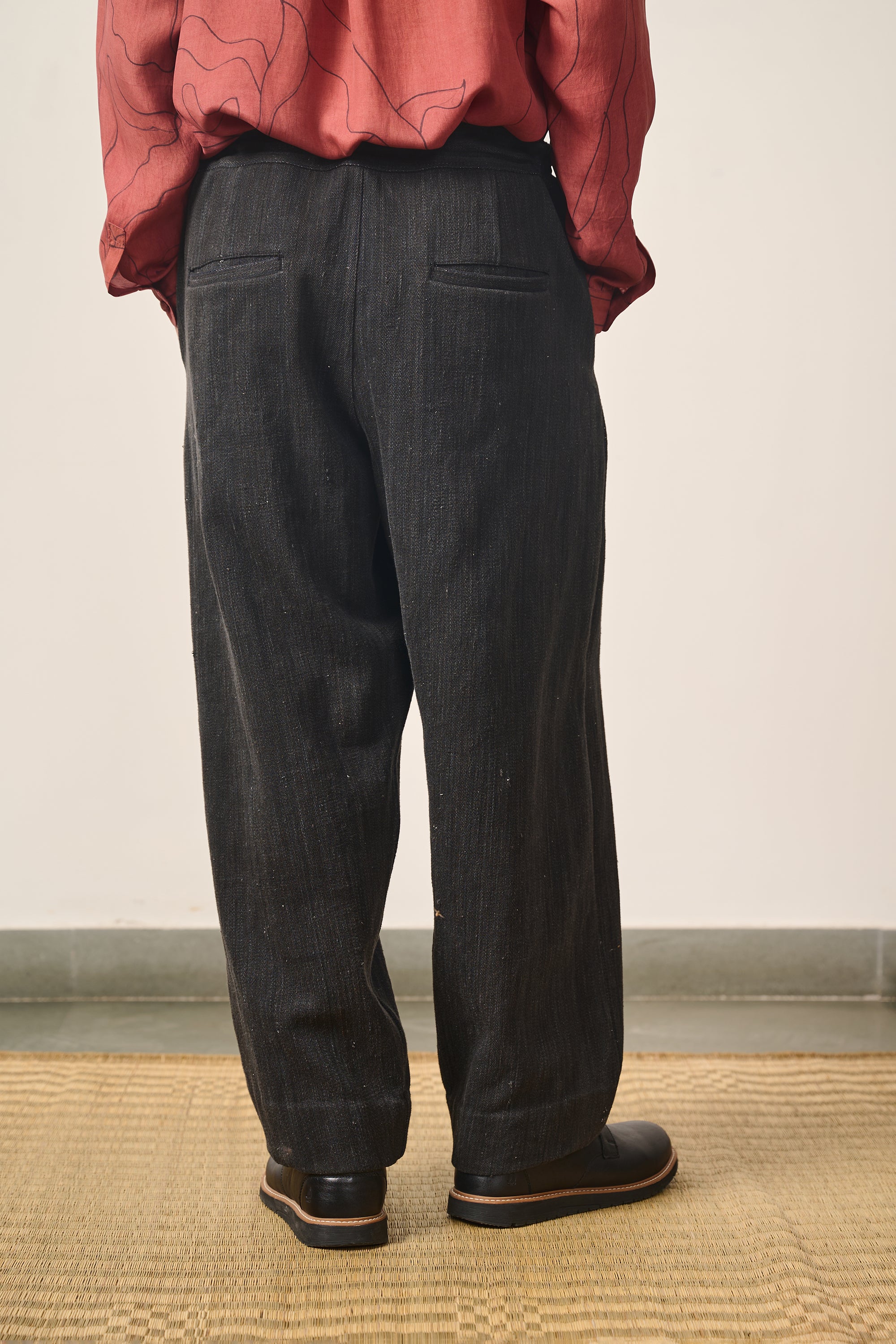 A back shot of a man wearing midnight night pant