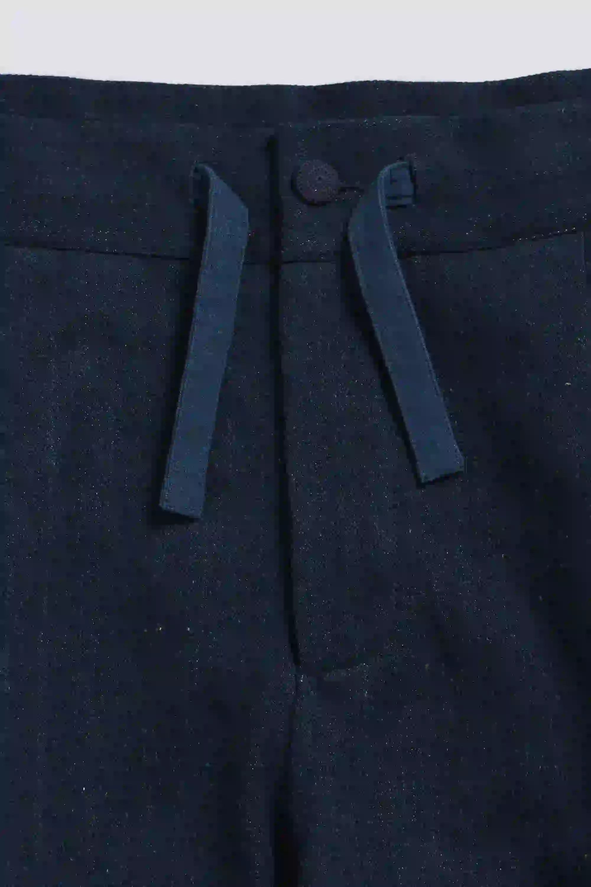 Close-up of dark blue fabric with a white border on a white background