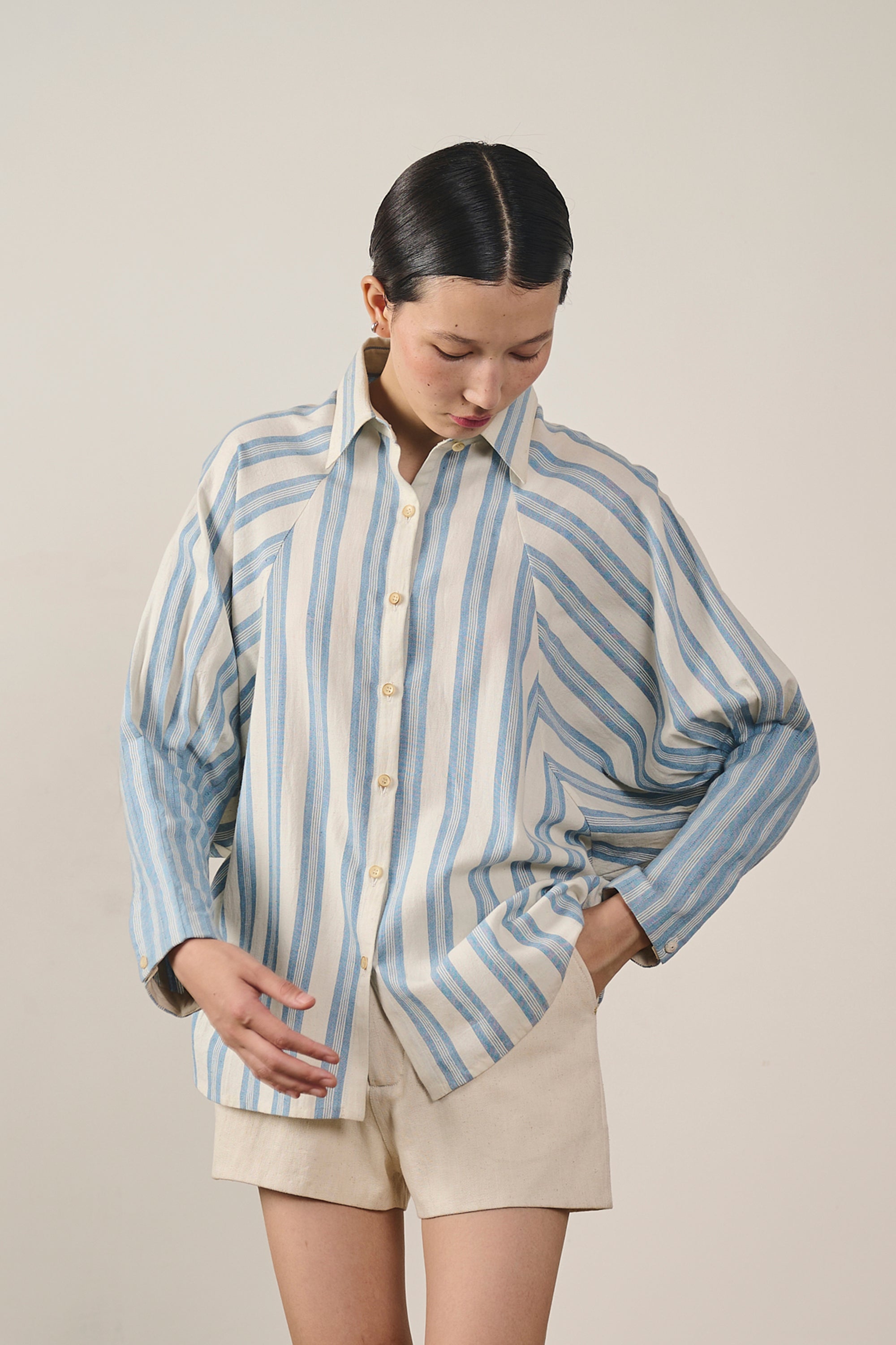 A woman wearing light indigo cotton shirt