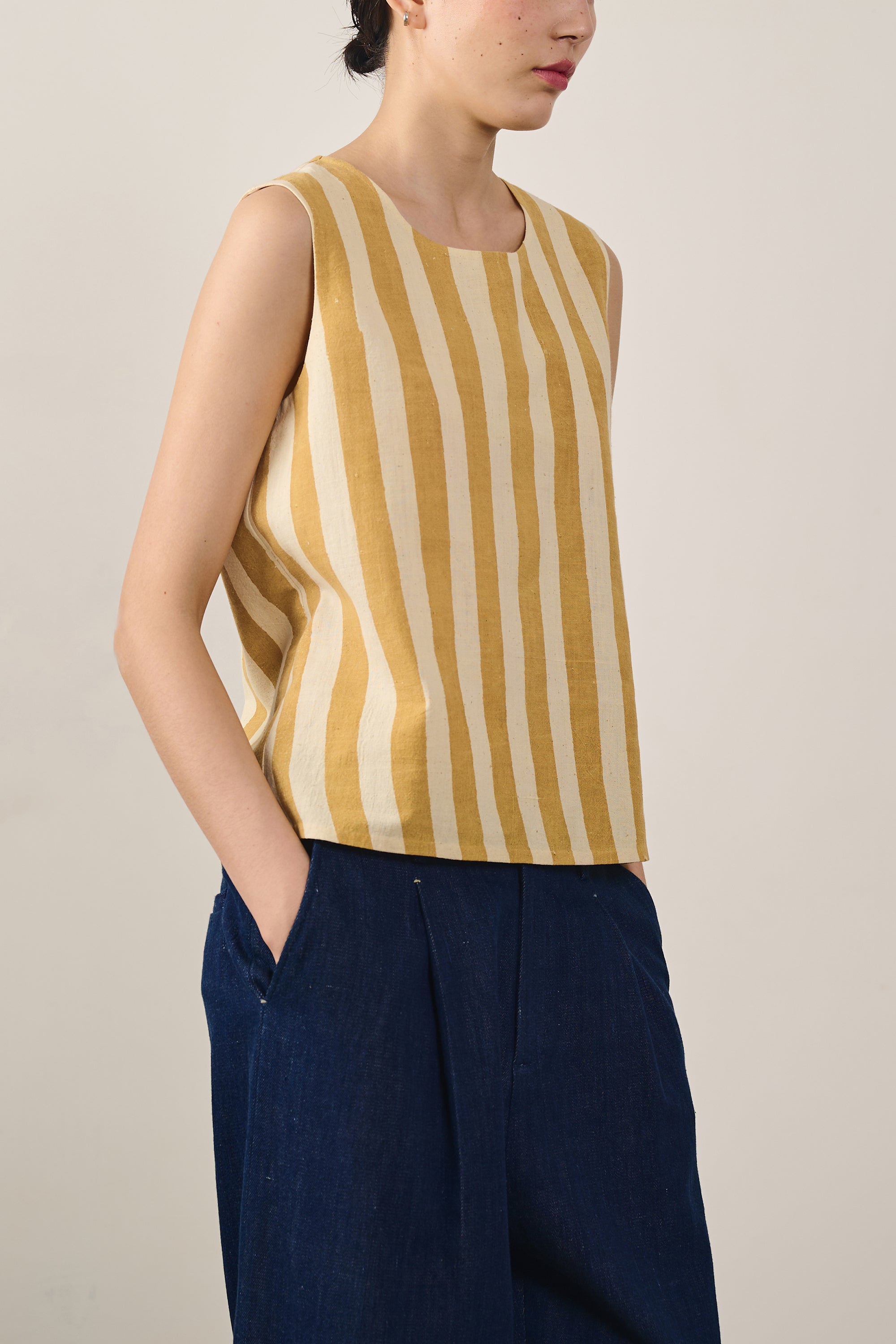 A woman wearing mustard yellow top