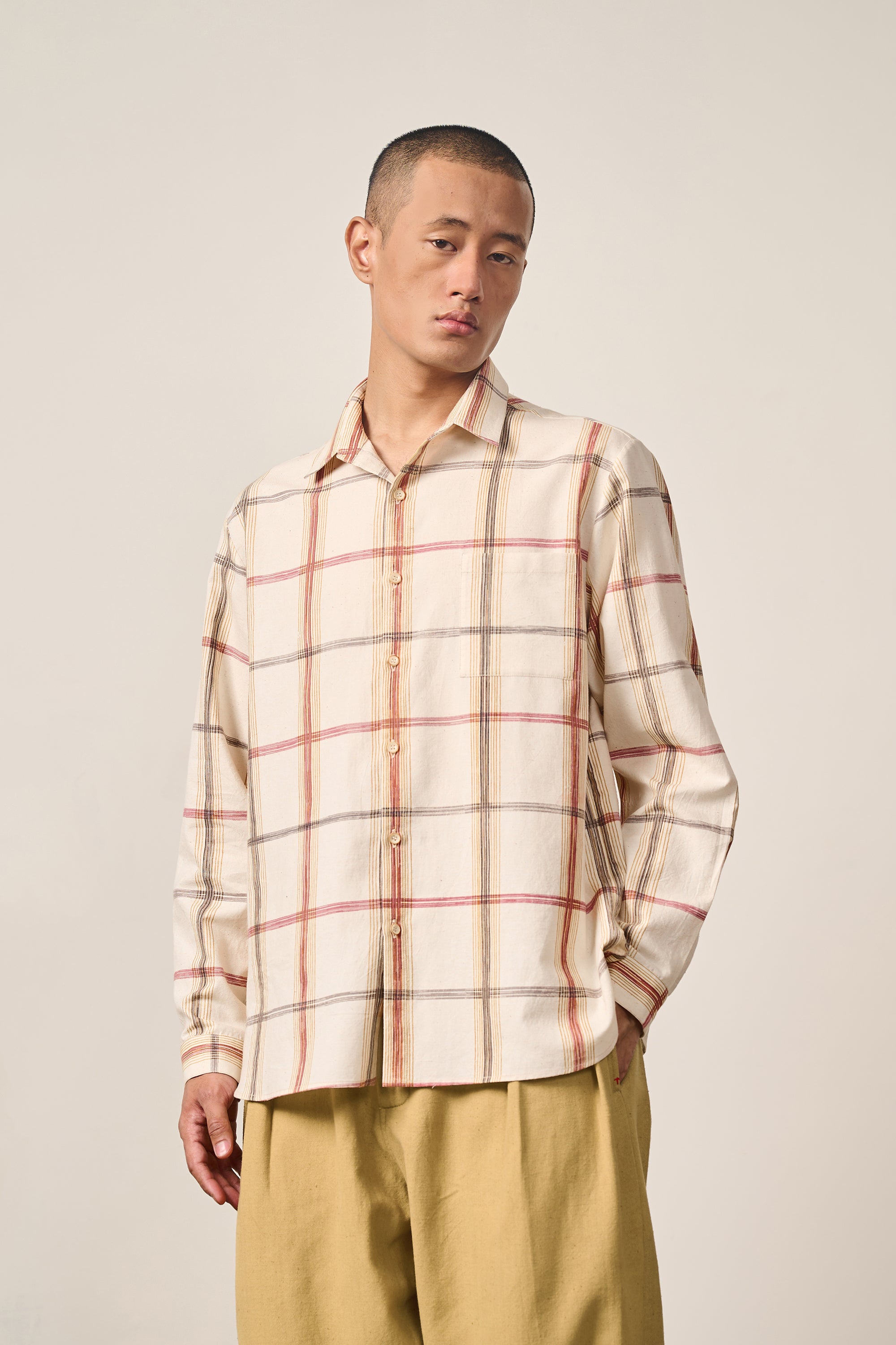 A man wearing cream shirt