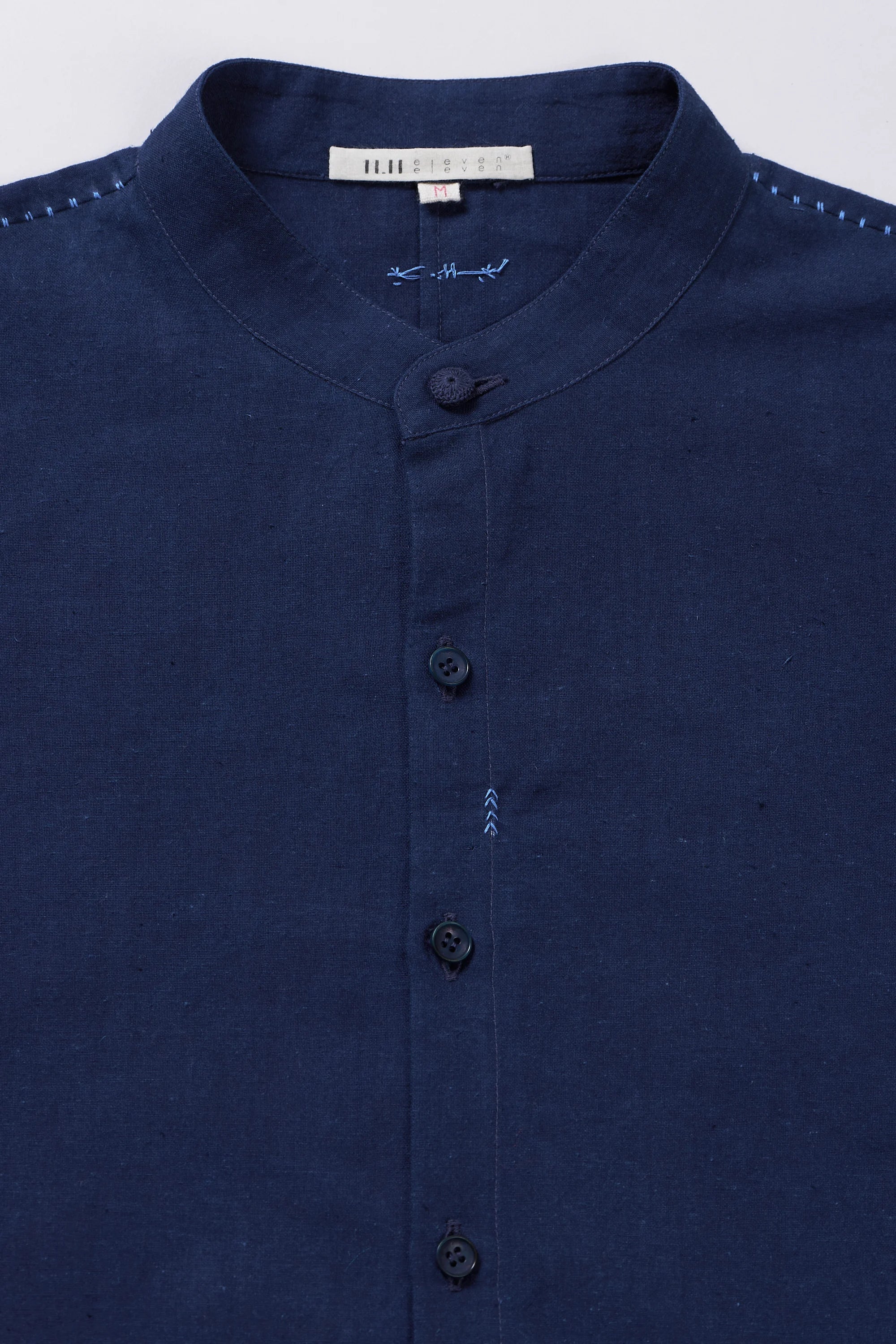 Fabric close-up with buttons and band collar