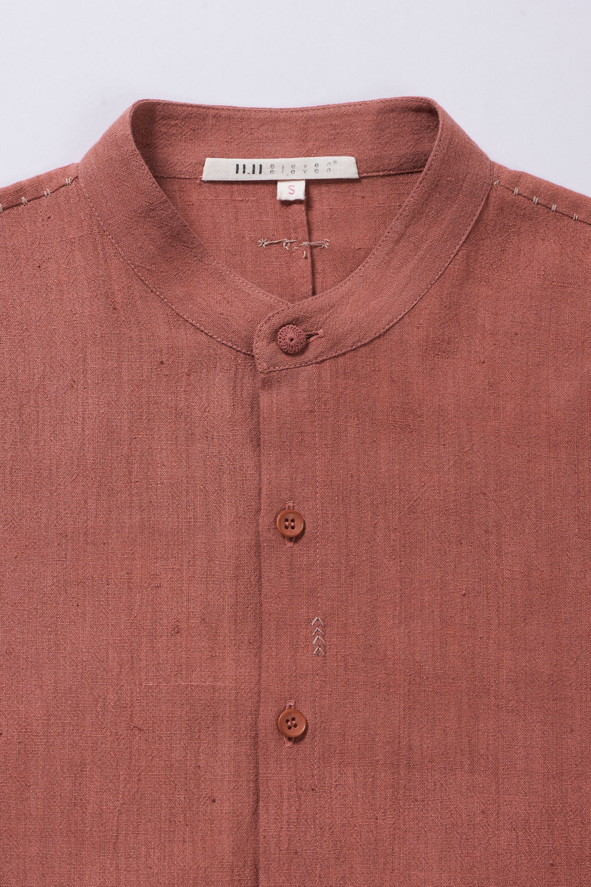 Fabric close-up with buttons and hand detailing