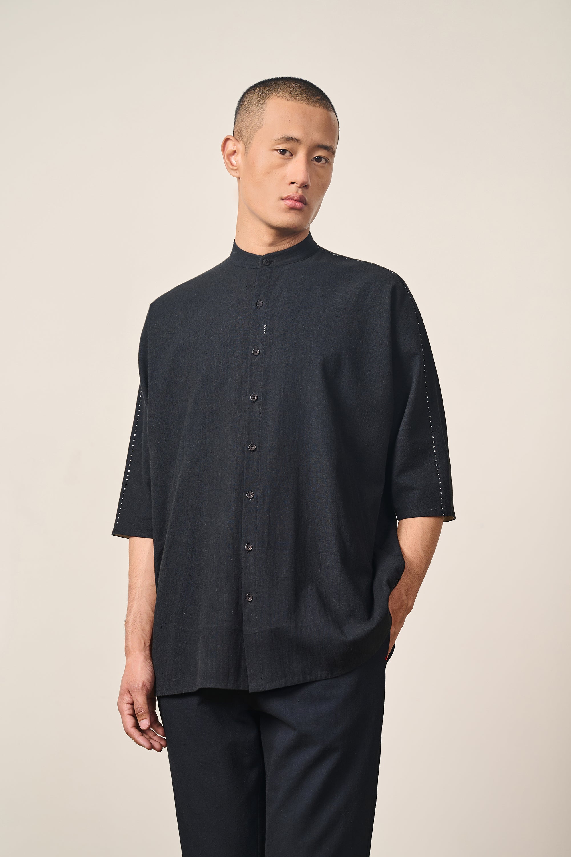A man wearing back cotton shirt