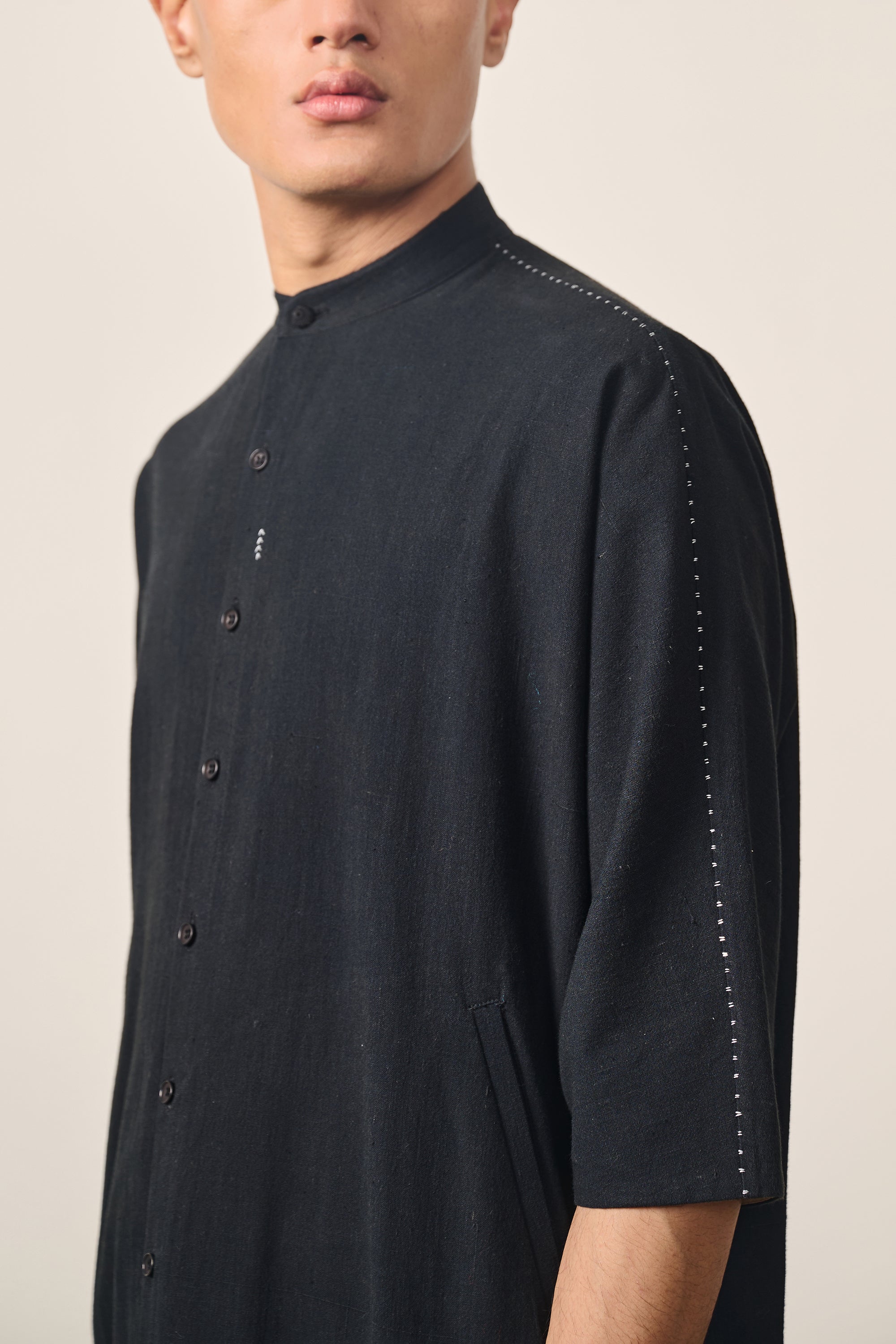 A man wearing back cotton shirt