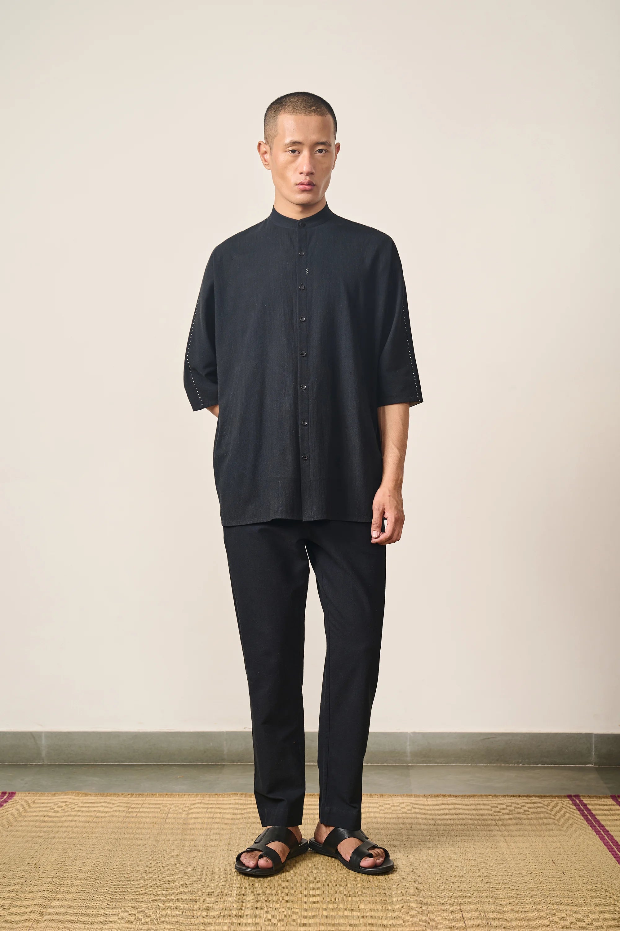 A man wearing black cotton shirt