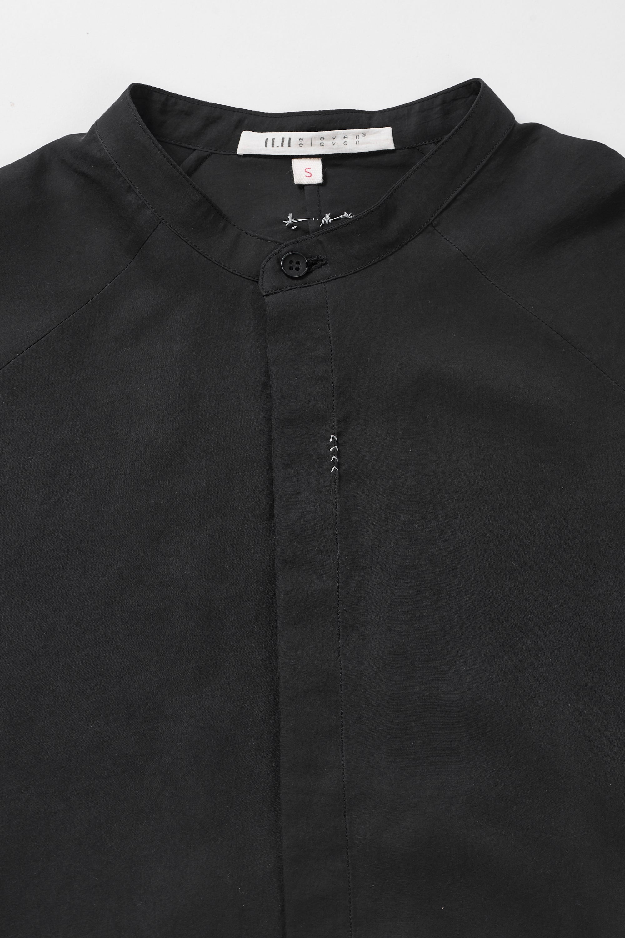 Fabric close-up with button and hand detailing