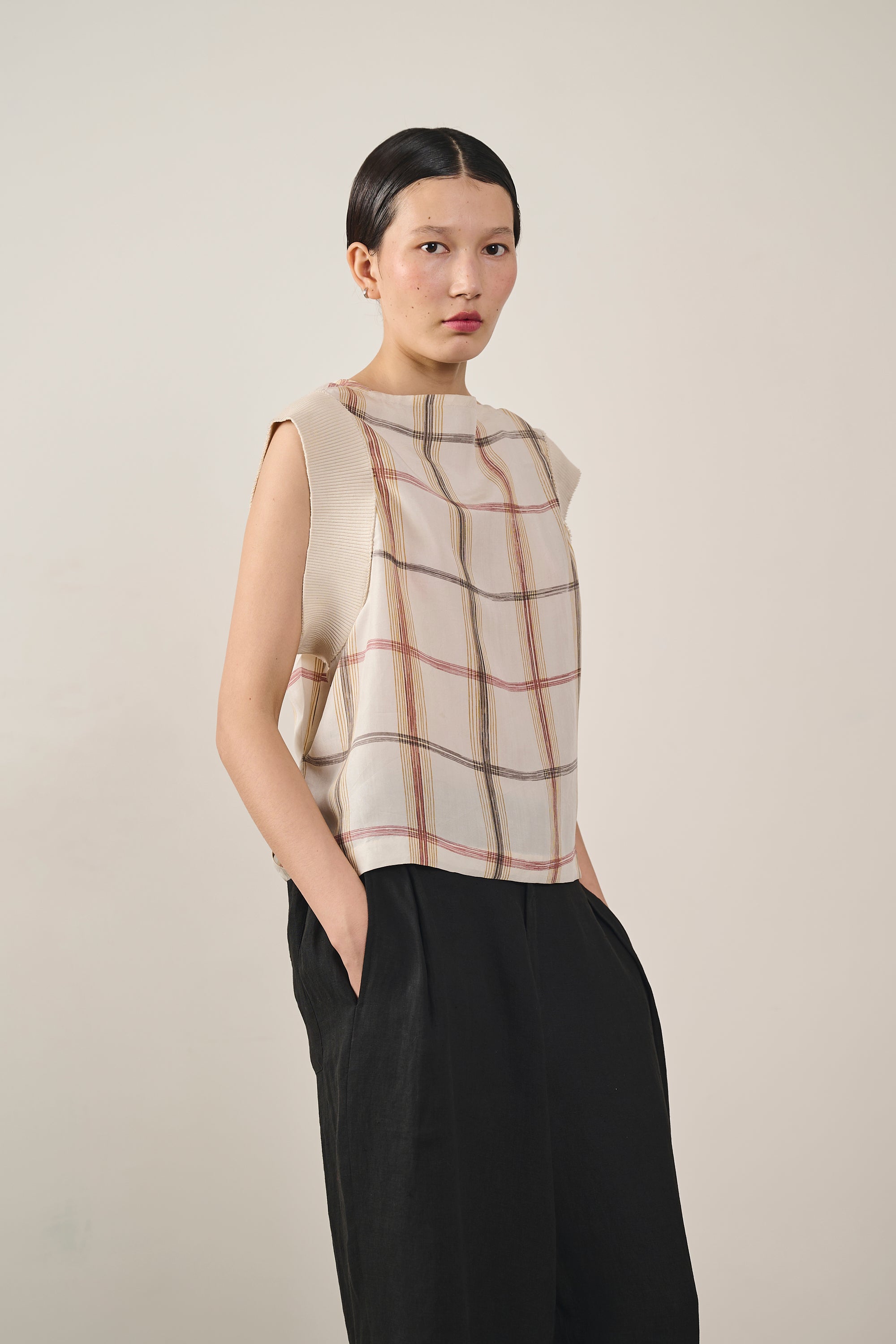 A woman wearing cream silk top