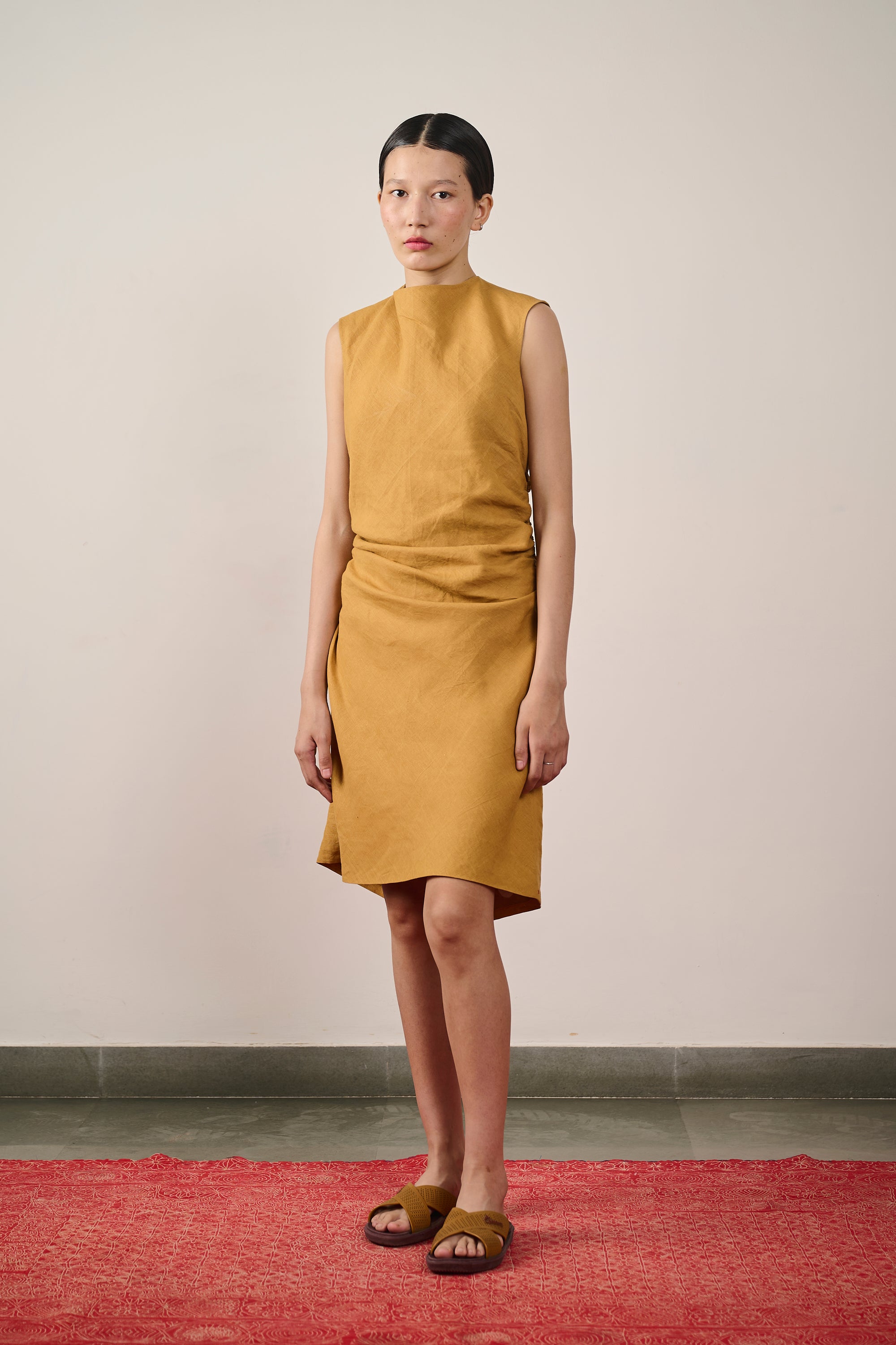 A woman wearing mustard yellow linen dress