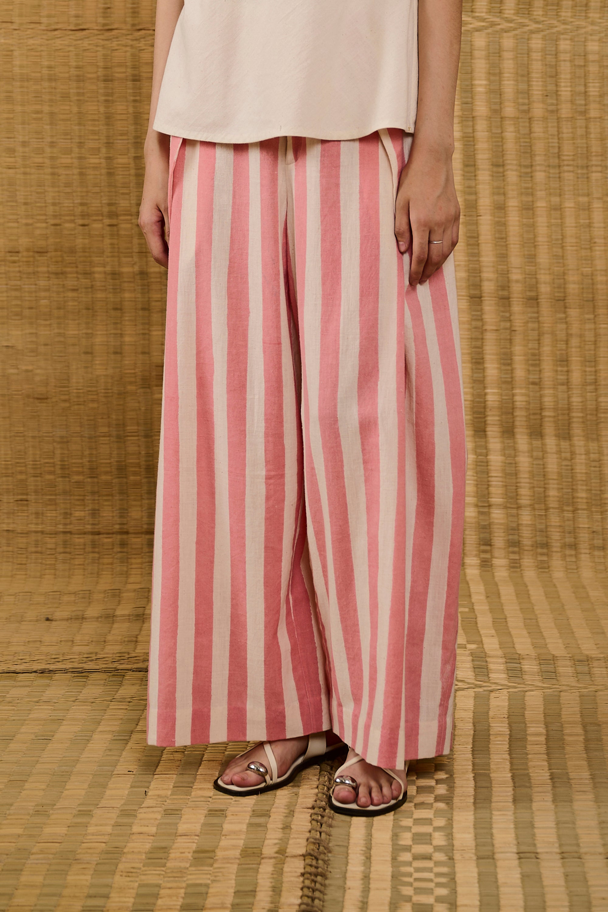A woman wearing pleat trouser with screen print
