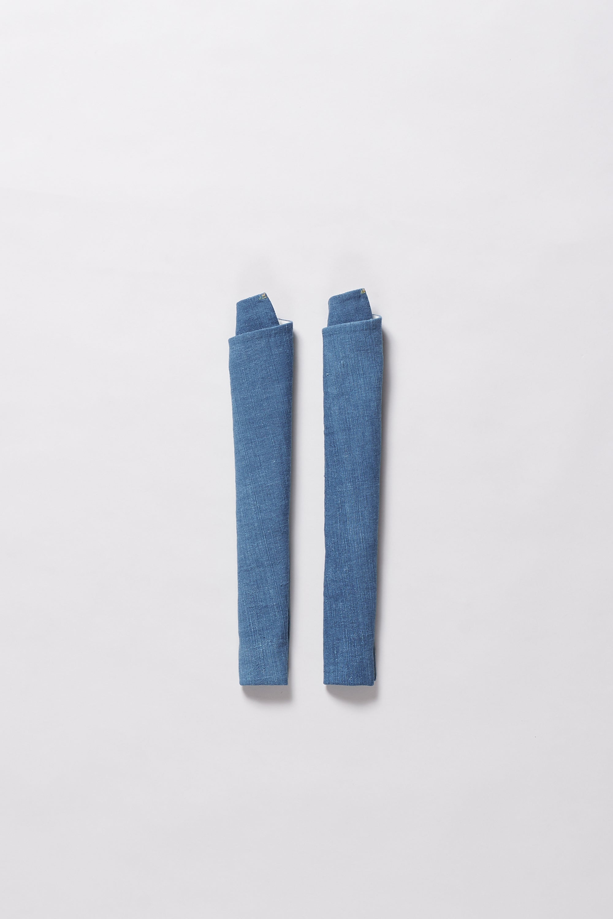 Light indigo towel roll on a light grey background