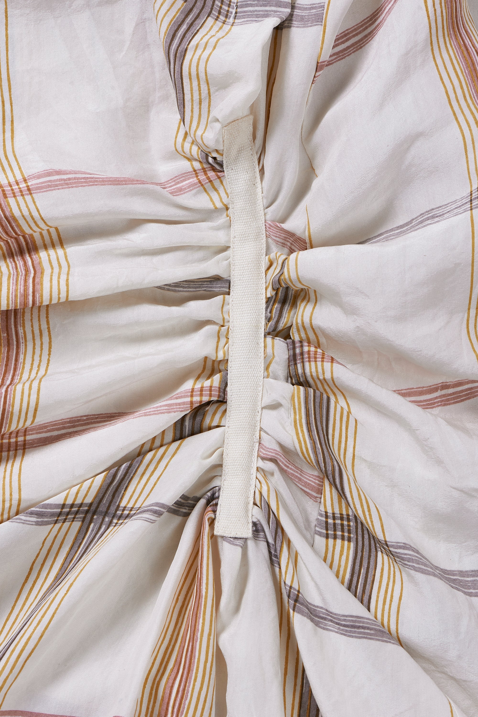 A close-up shot of a cream dress