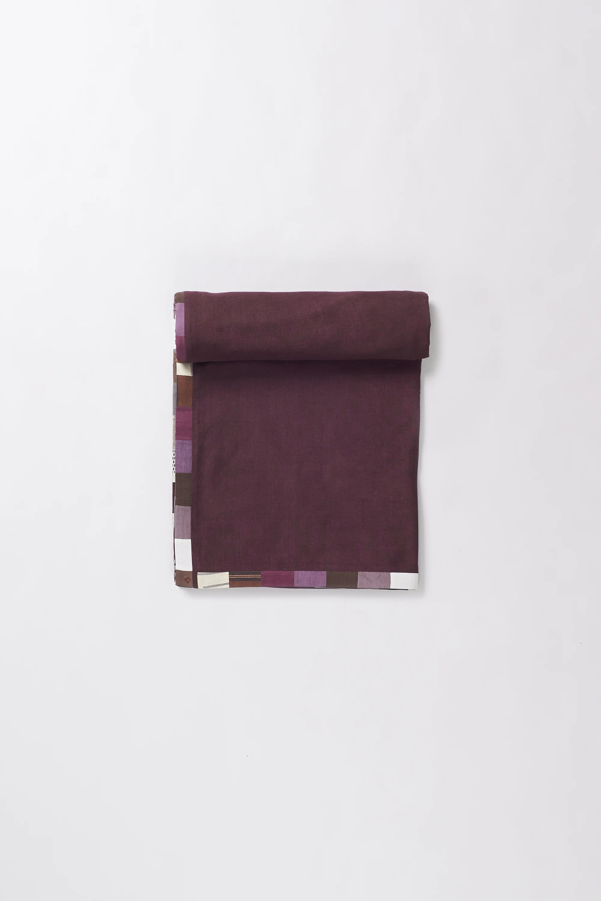 Colorful patterned fabric roll on a white background