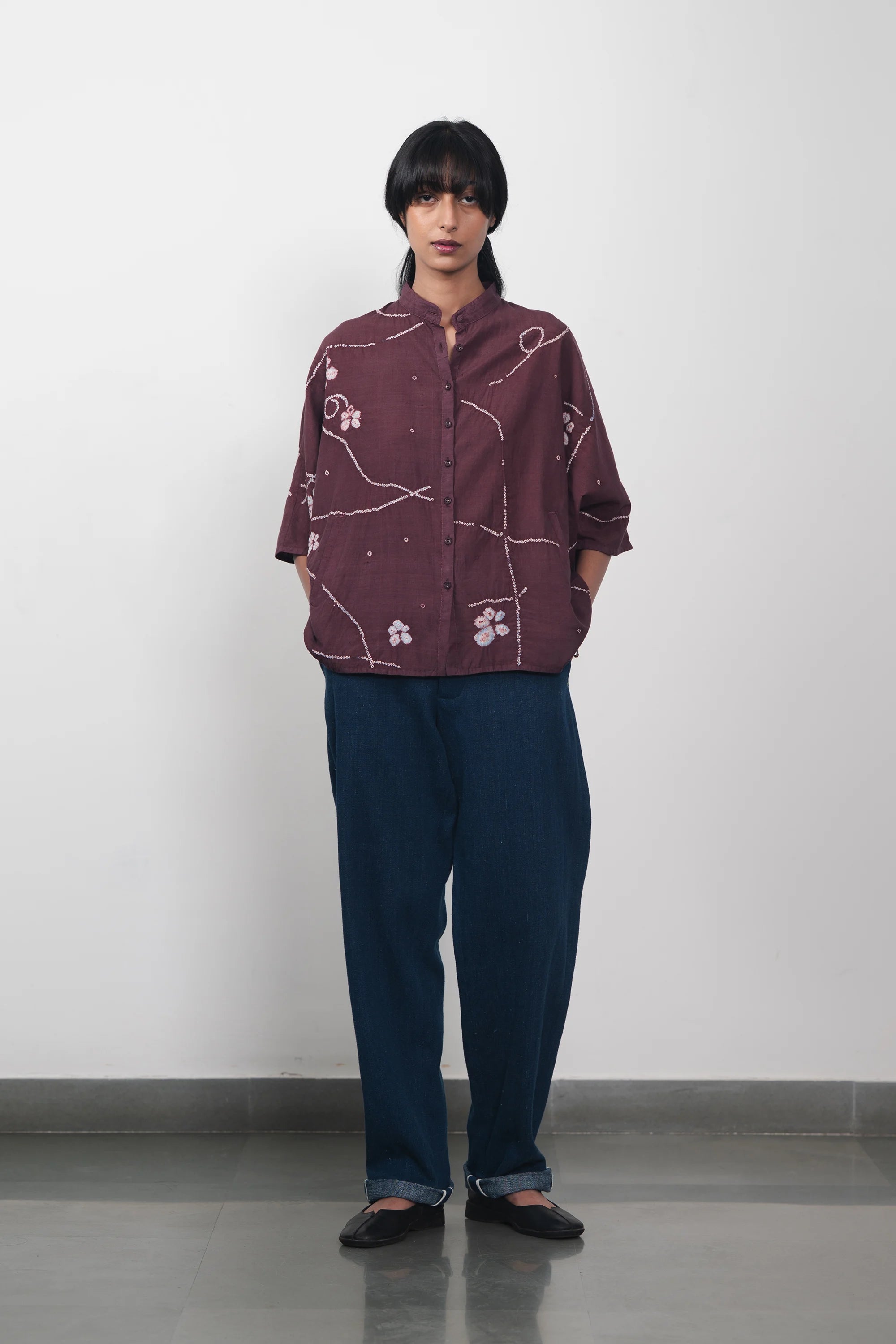 A woman wearing denim cotton pant with bandhani shirt