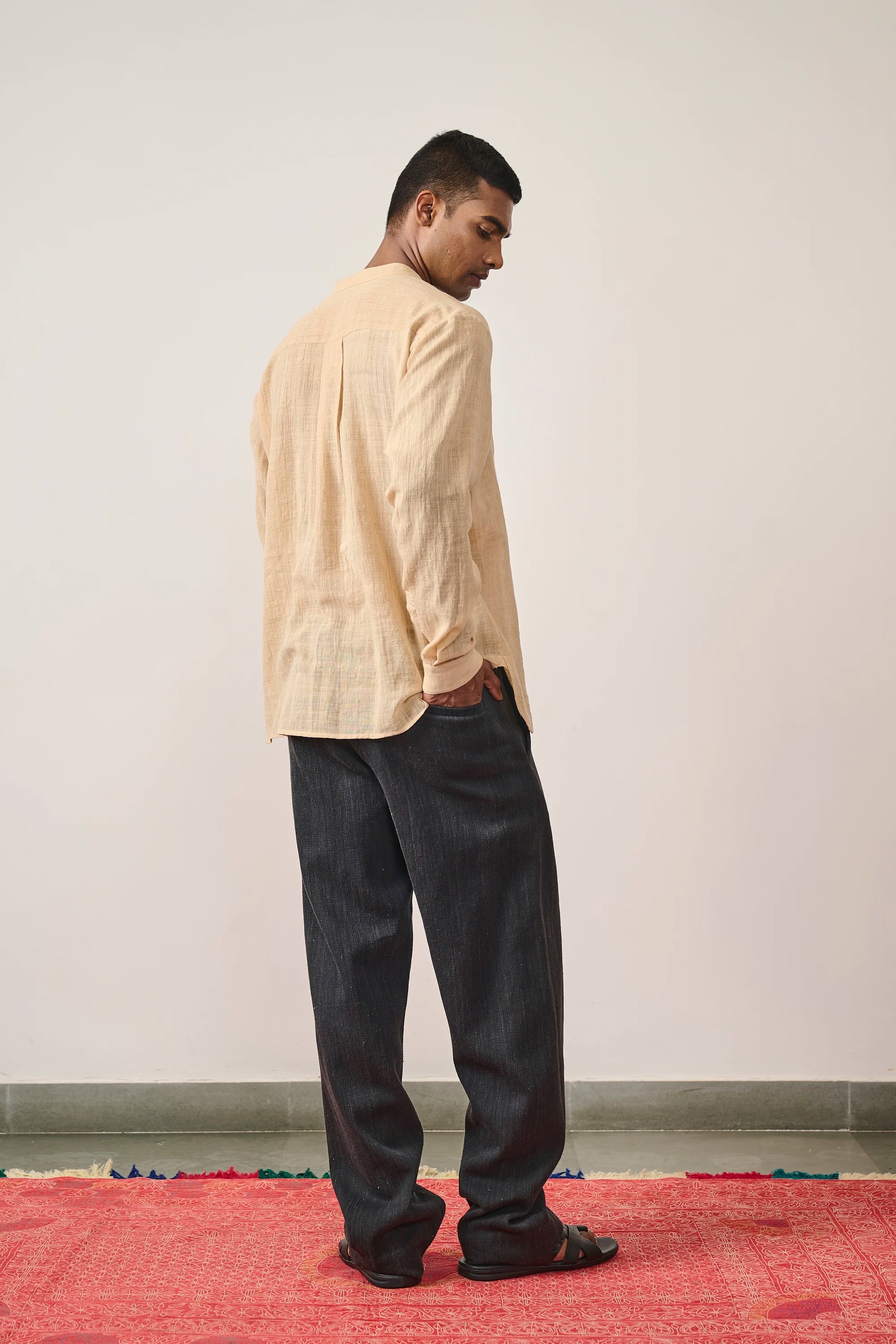 A side shot of a man wearing midnight indigo pant