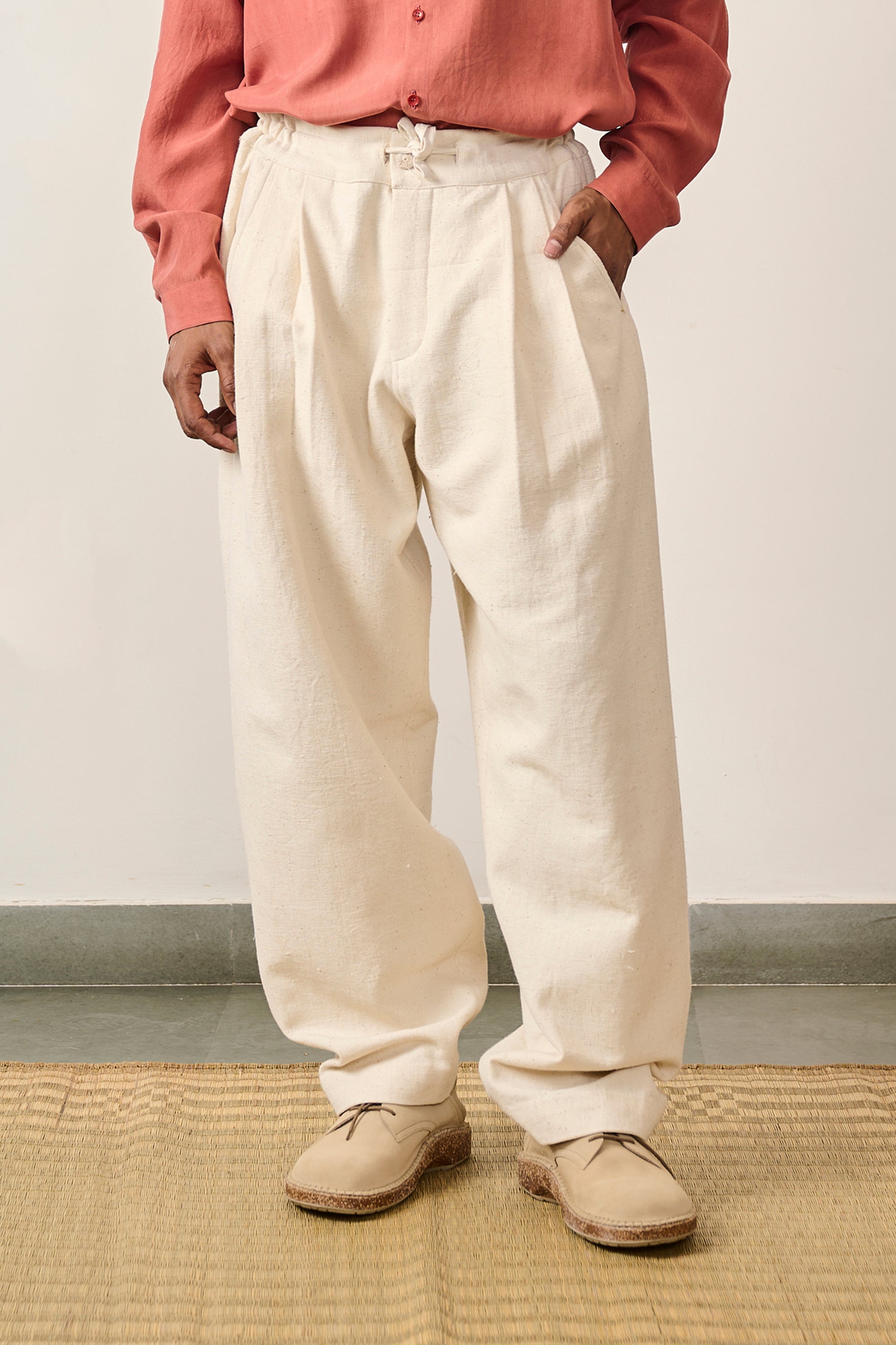 A man wearing ecru cotton pant