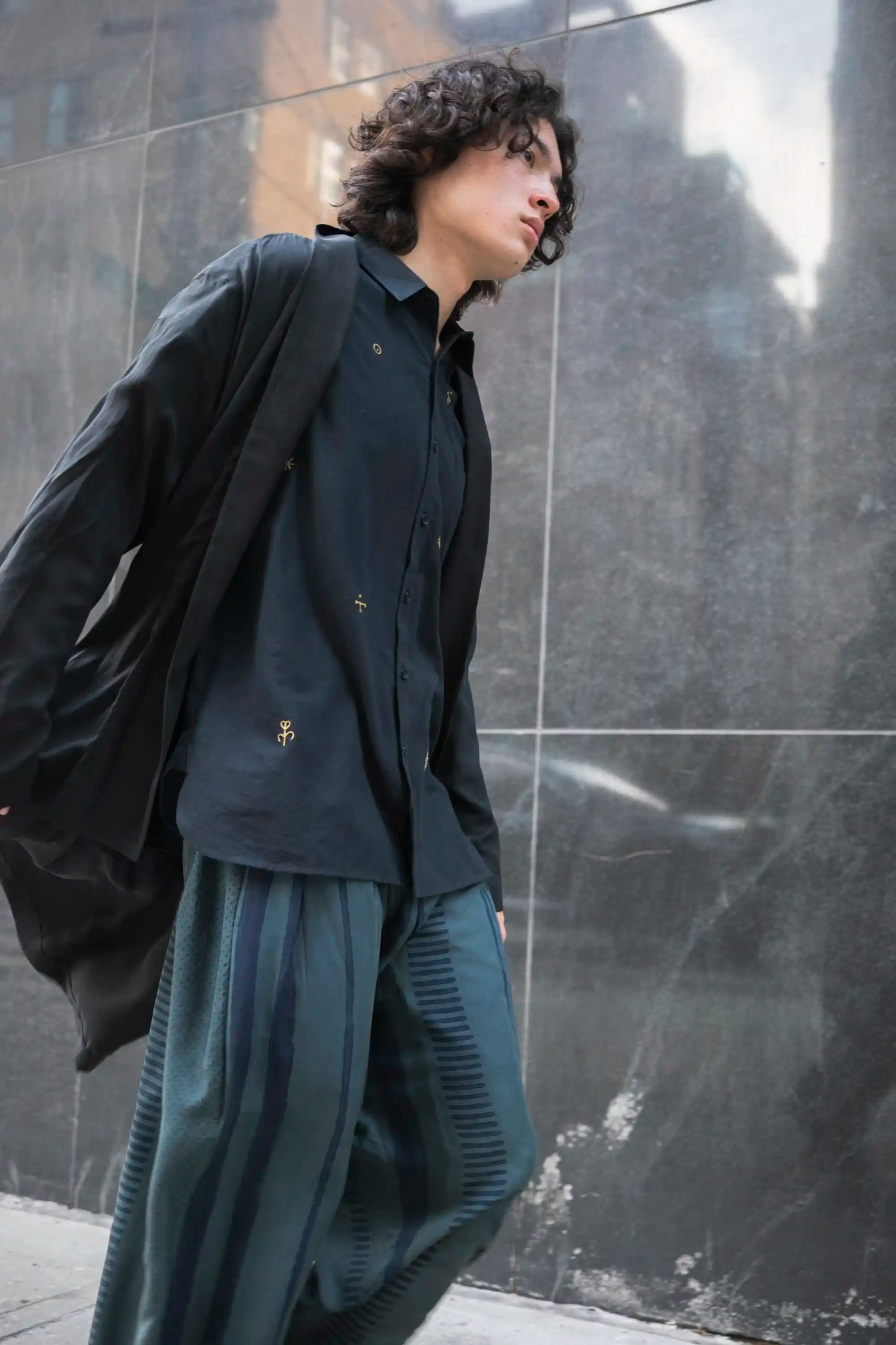 A man wearing black block printed silk pant