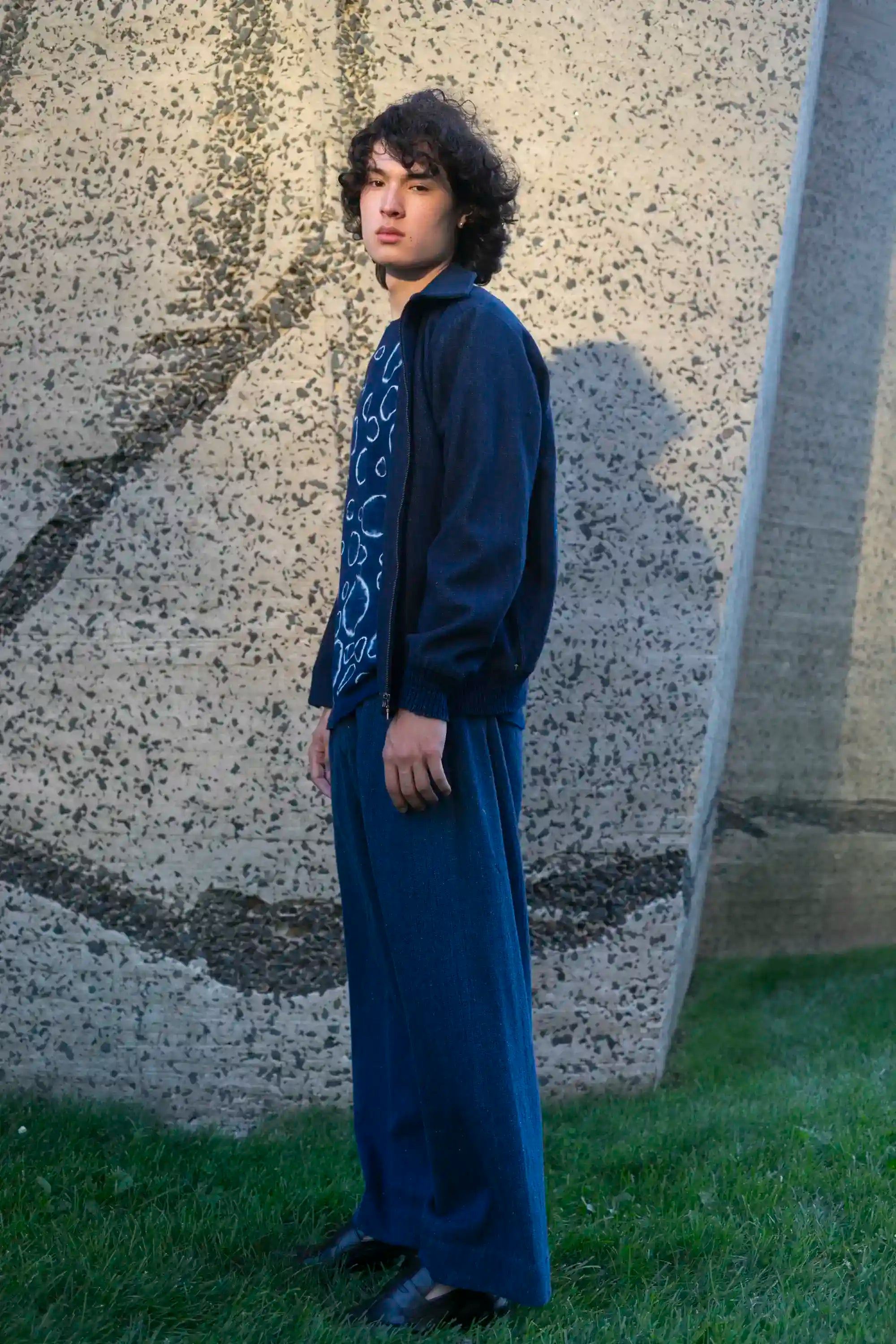 A side shot of a man wearing denim jacket