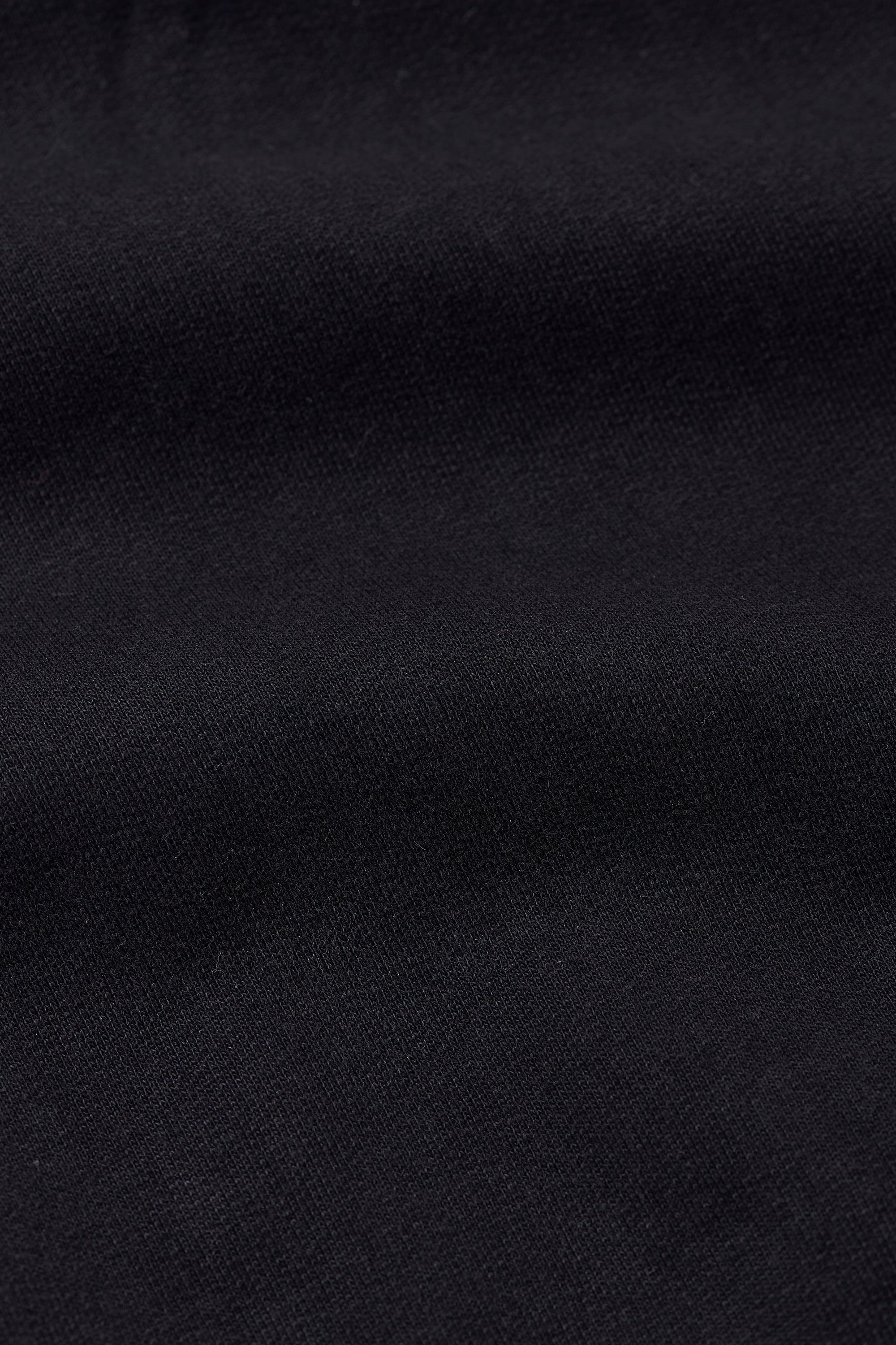 A back shot of a woman wearing black sweatshirt
