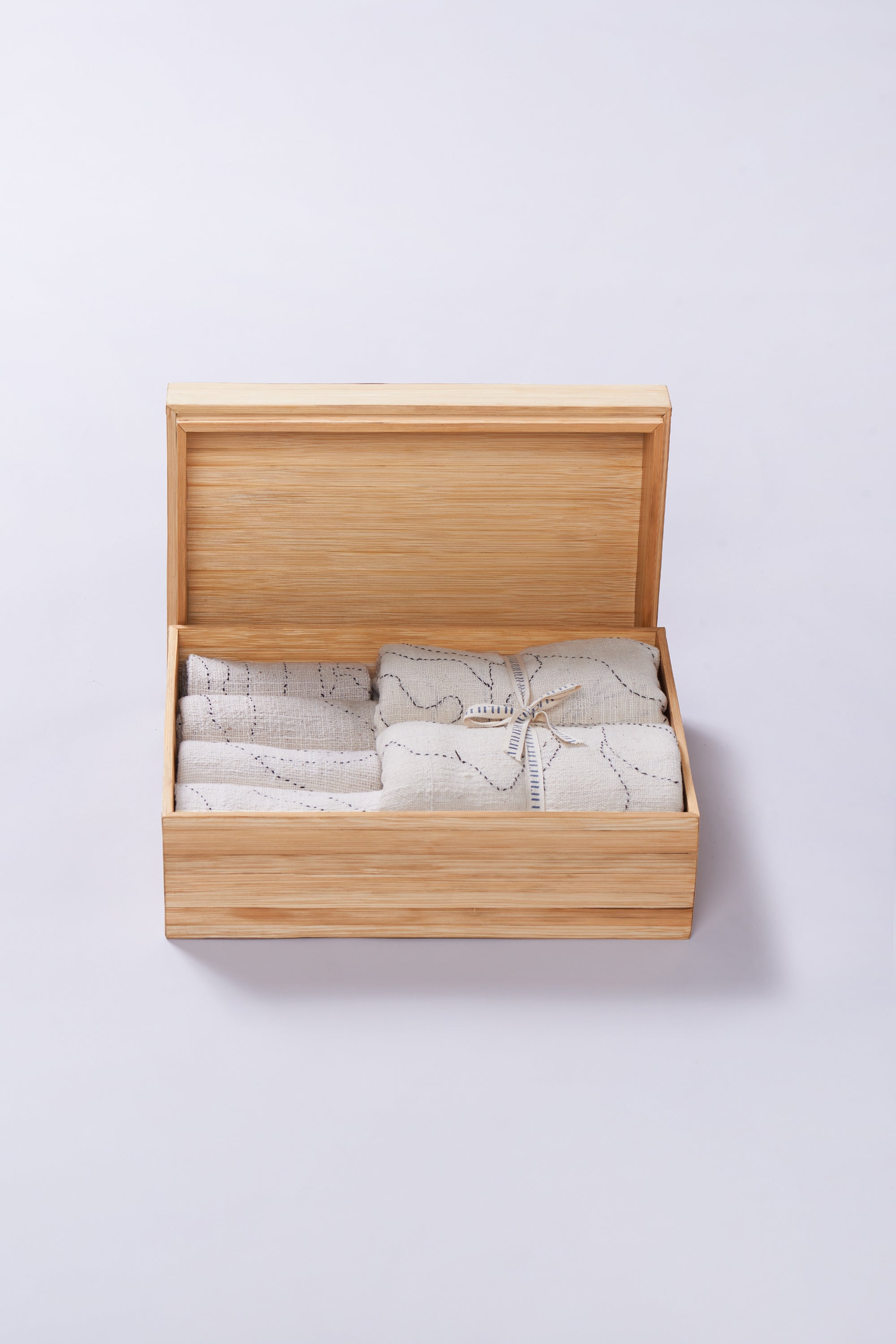 Open wooden box with ecru towel