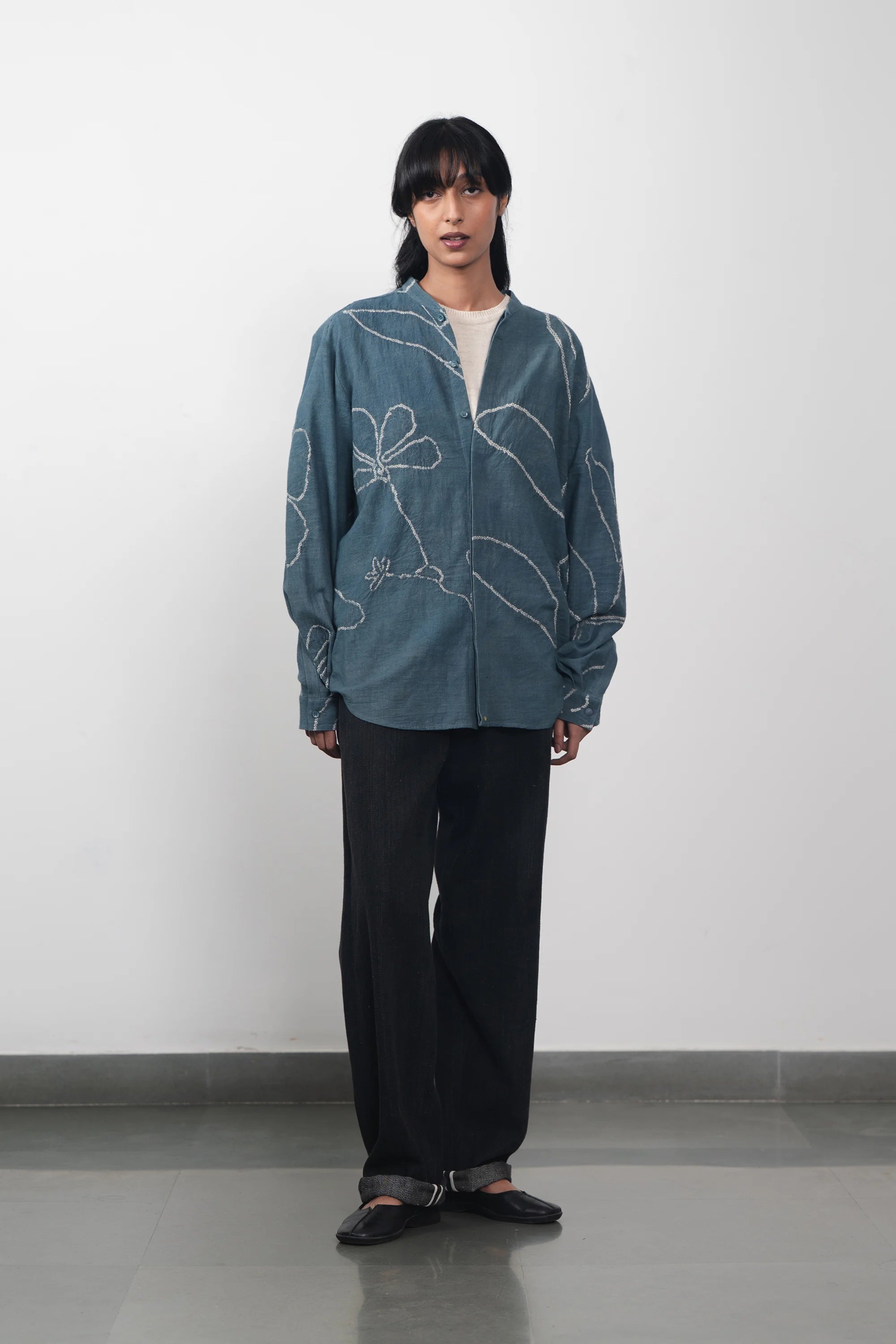 A woman wearing ash indigo shirt