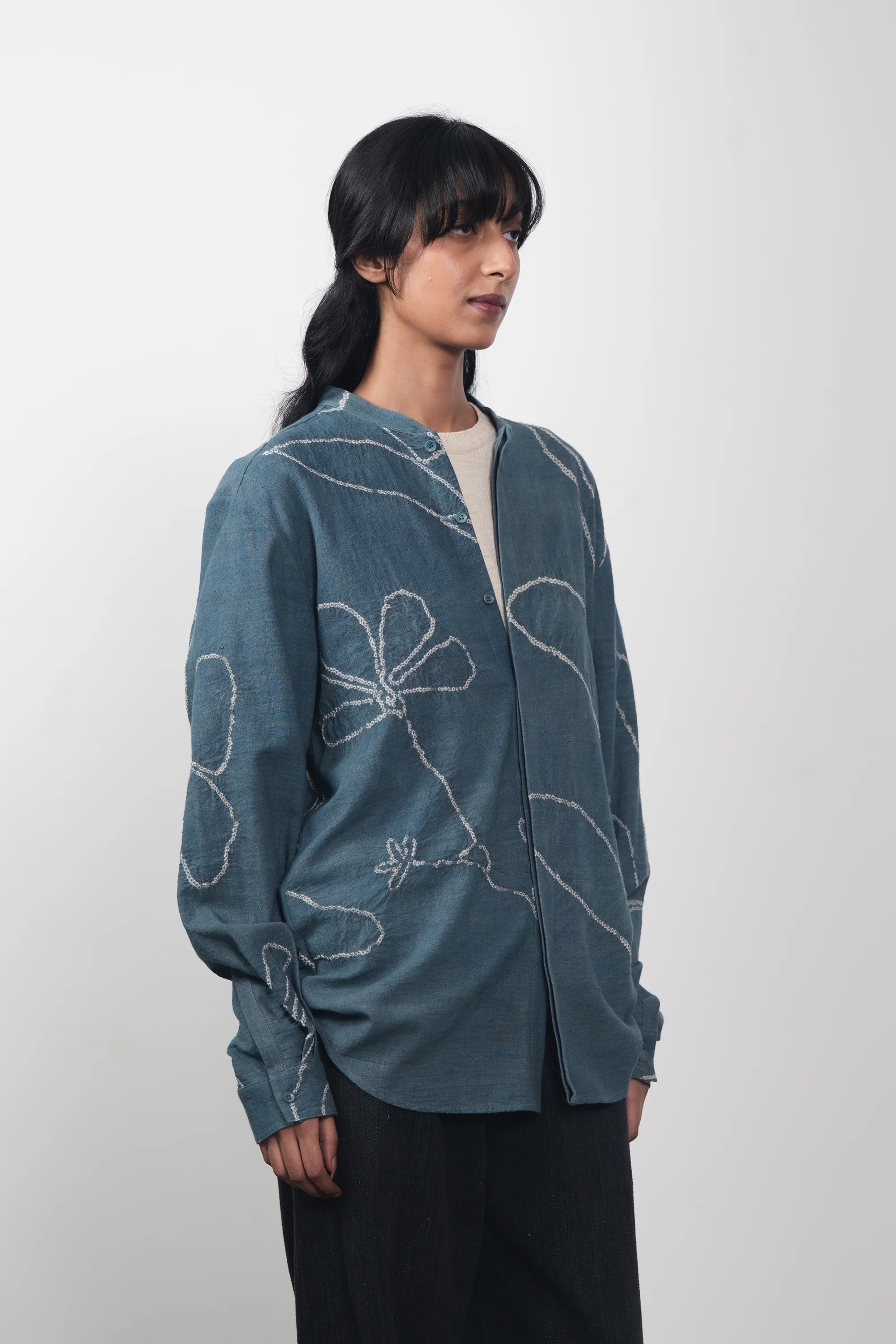 A woman wearing ash indigo bandhani shirt