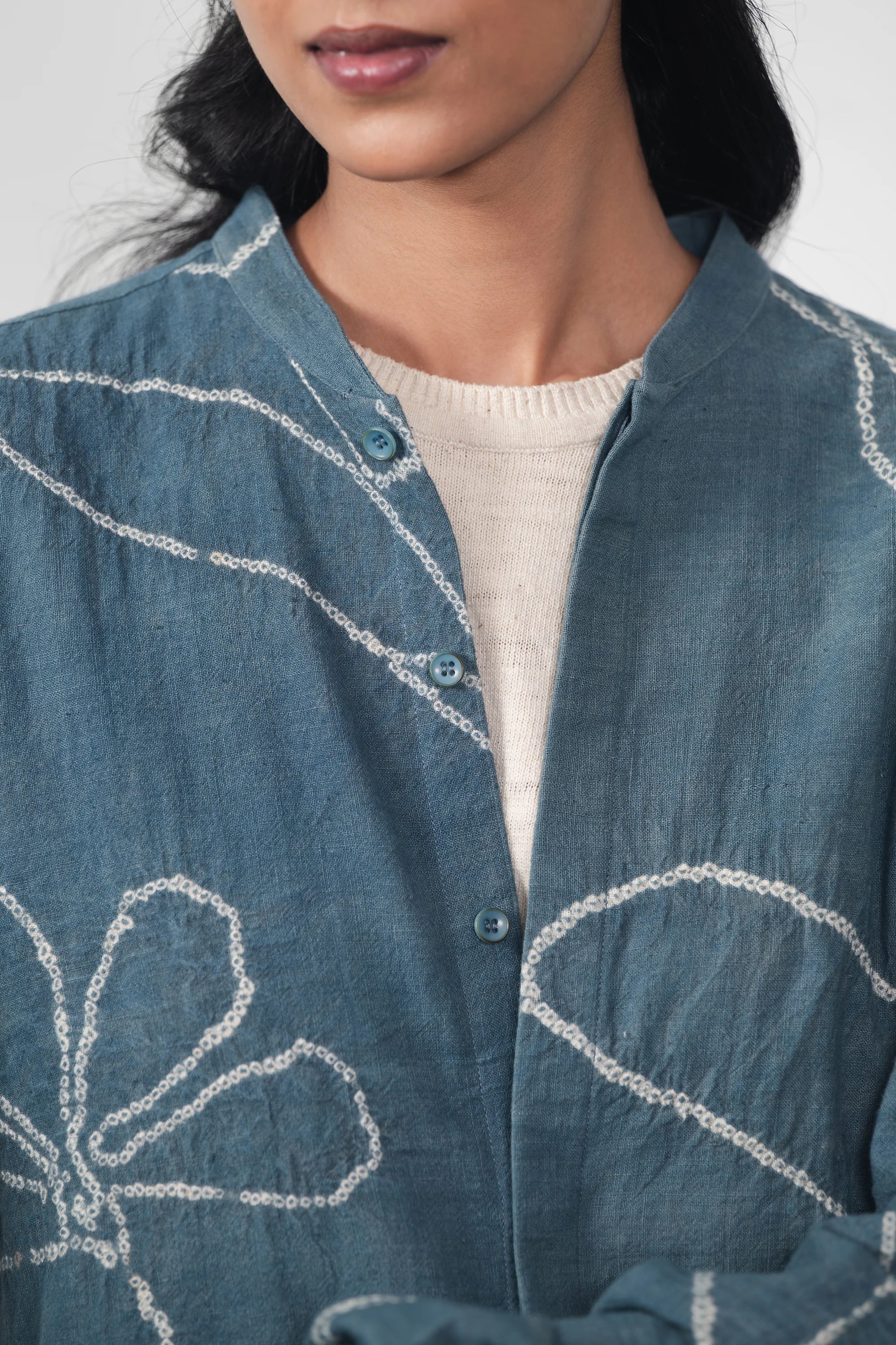 A close-up shot of a woman wearing ash indigo shirt