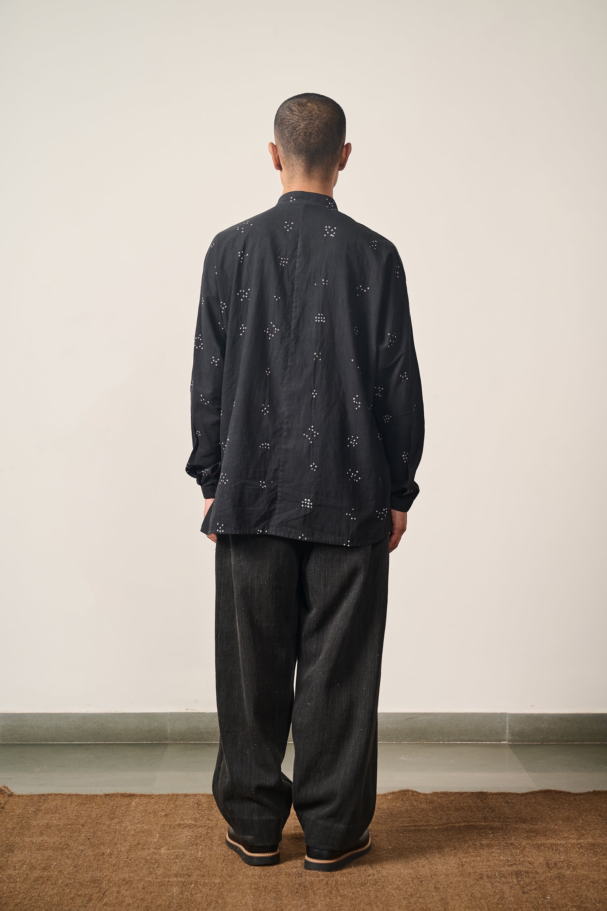 A back shot of a man wearing black shirt