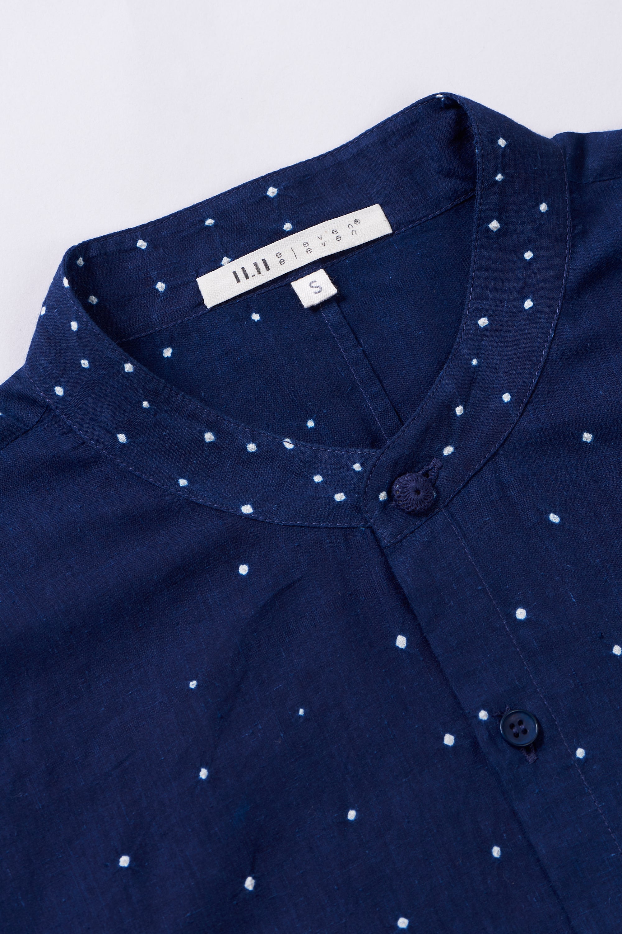 Fabric close-up with buttons and band collar