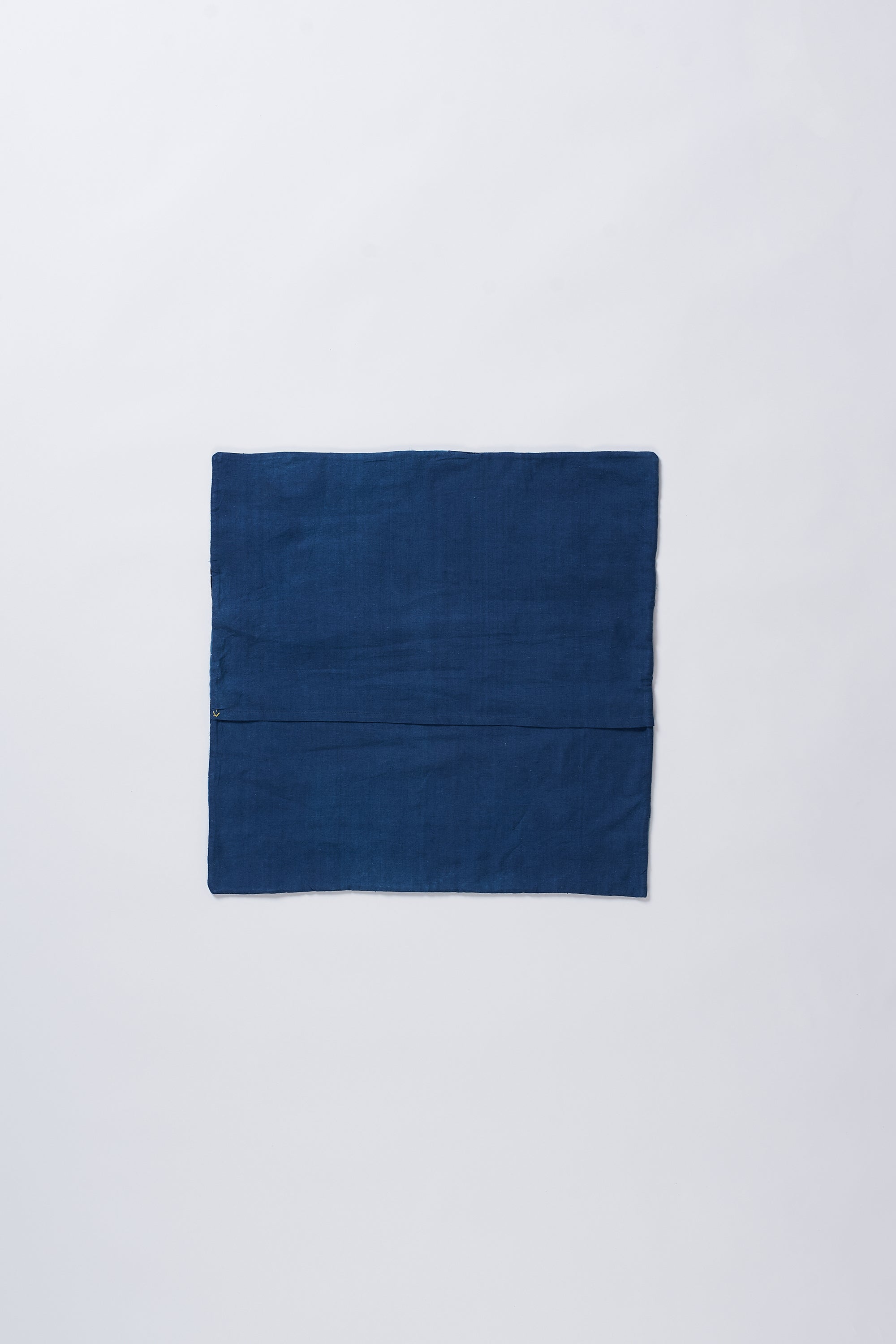 Back image of a patchwork ecru cushion
