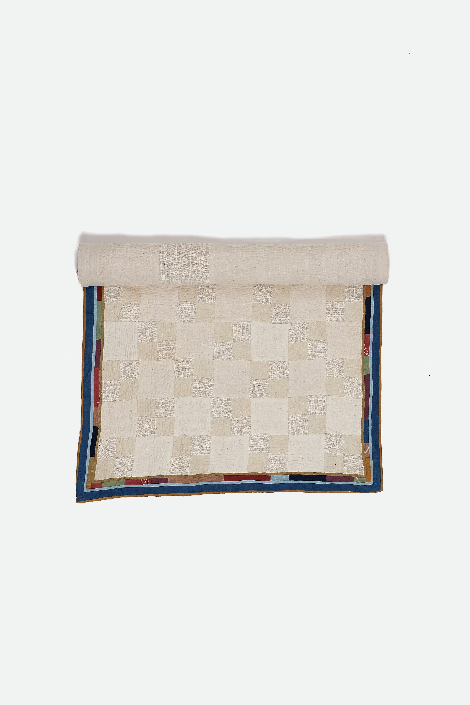 Ecru quilt roll on a light grey background