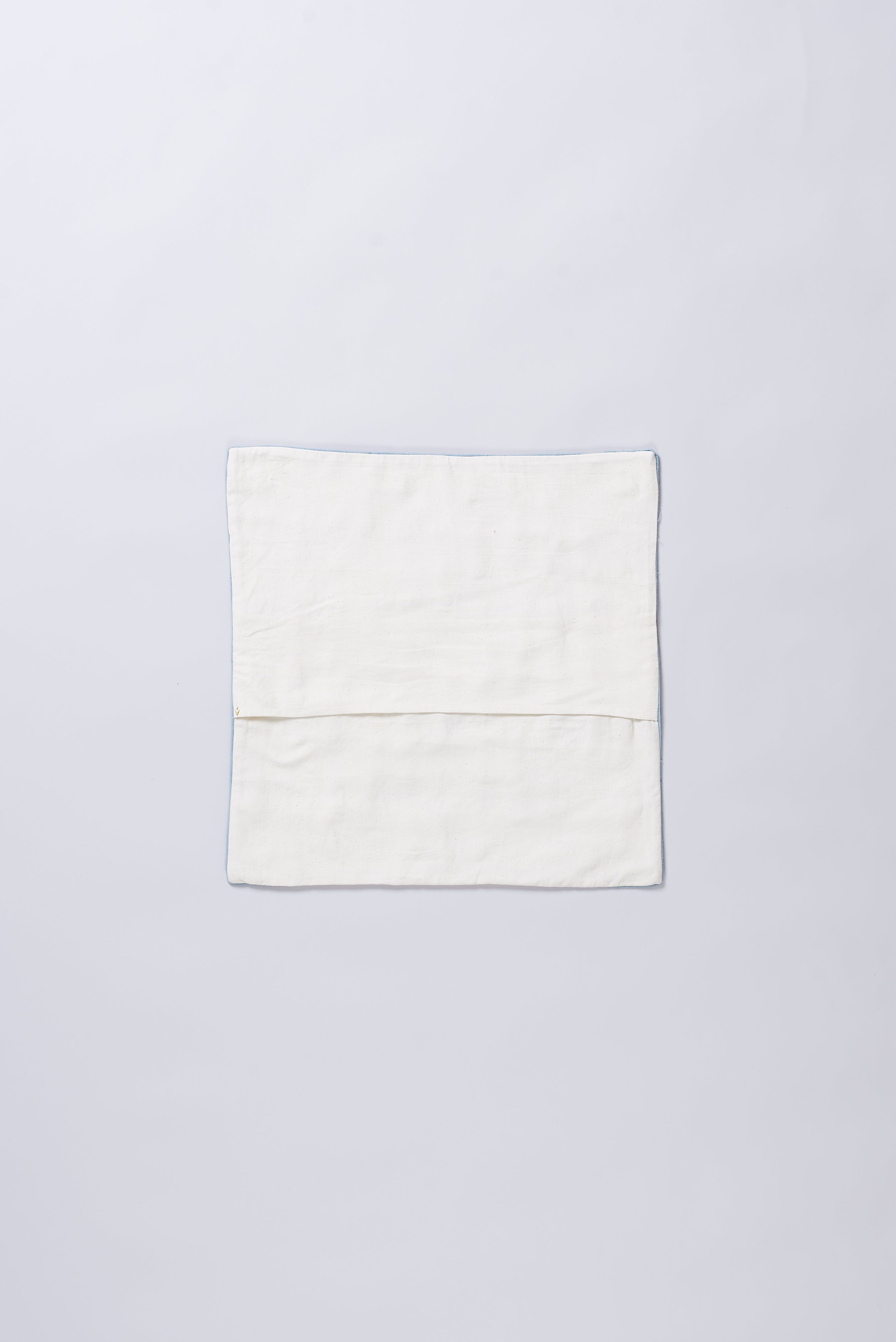 Back image of a patchwork ecru cushion