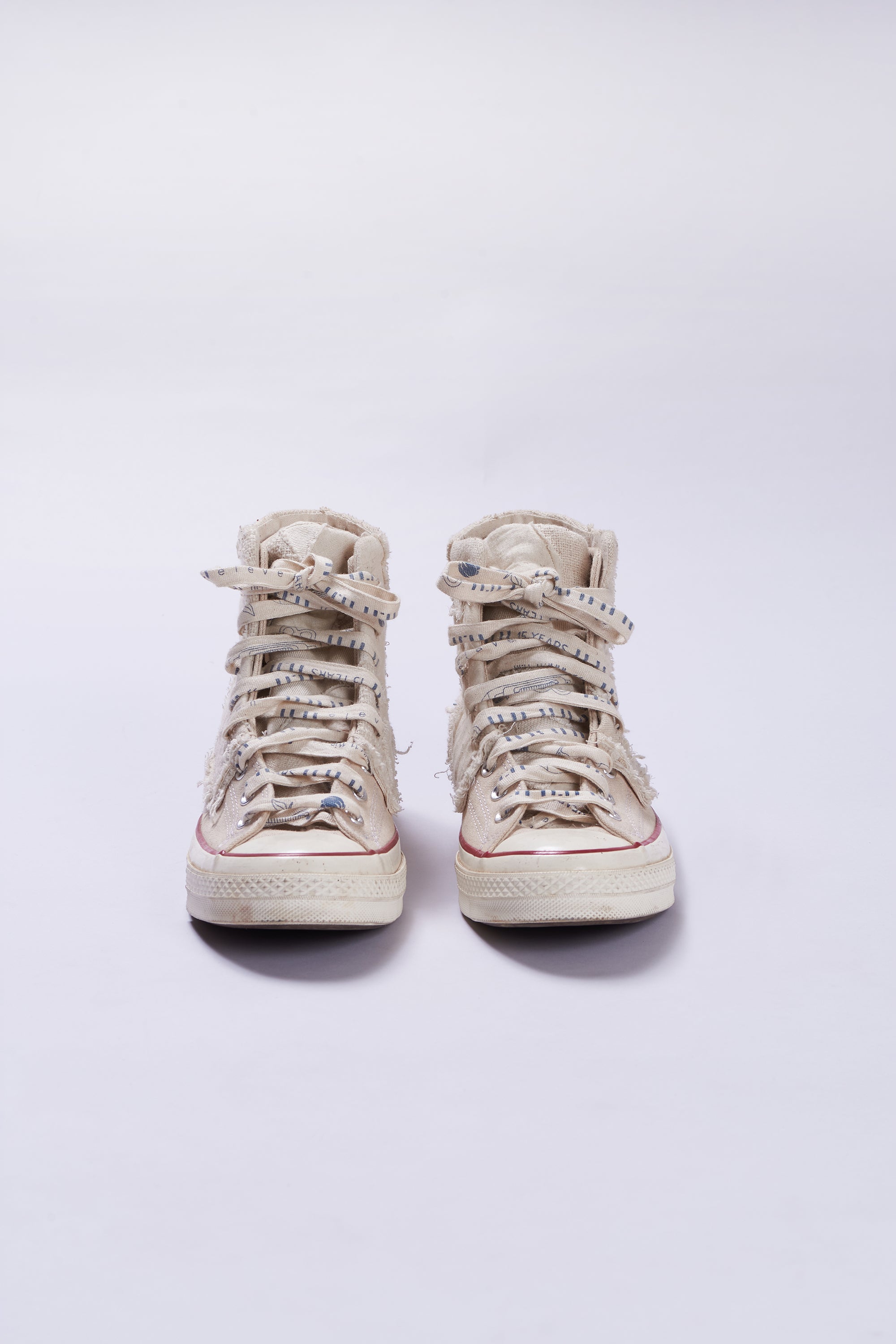 Front image of a ecru shoes with patchwork