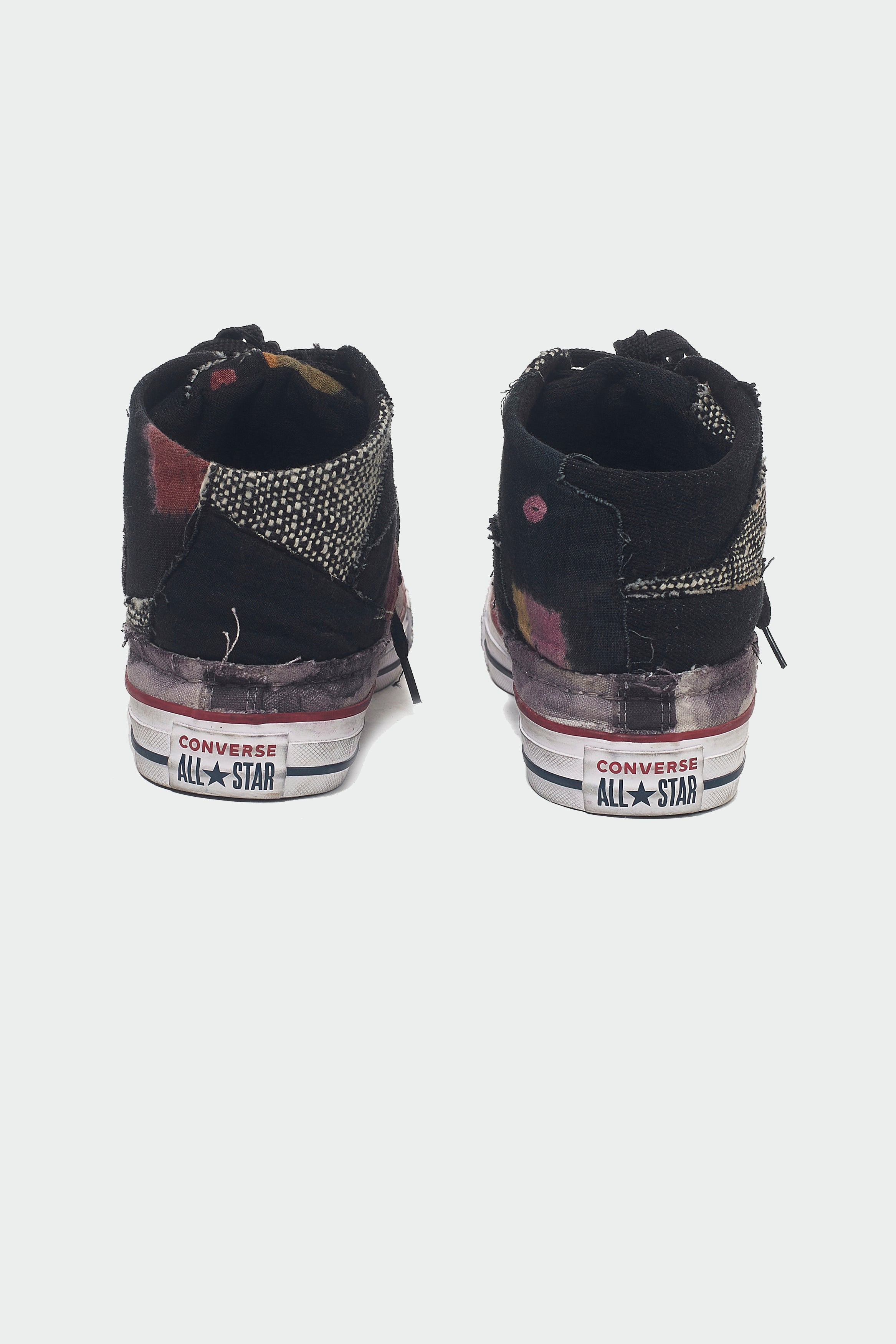 A back shot of a black converse shoes