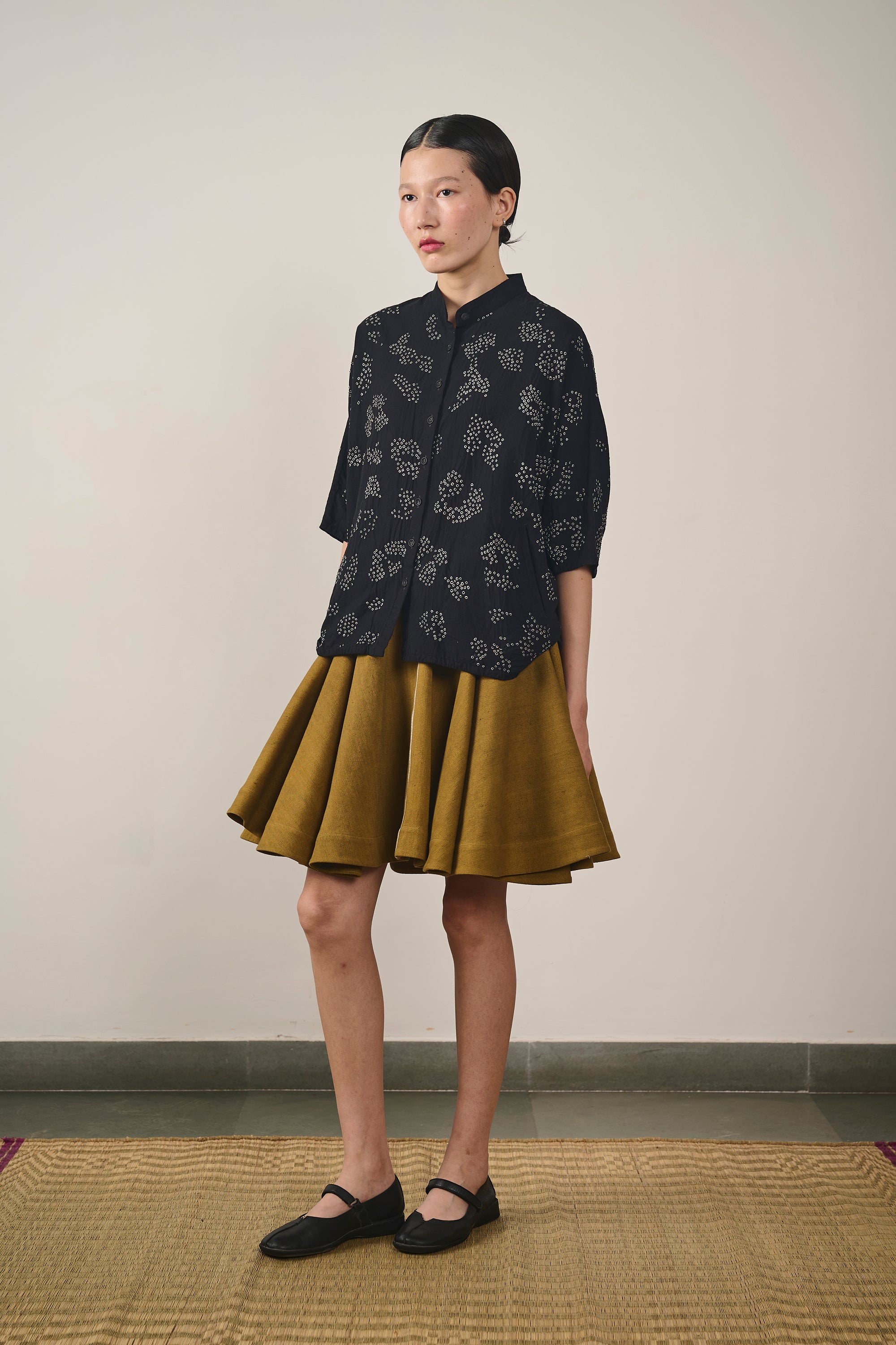 A woman wearing cotton black bandhani shirt