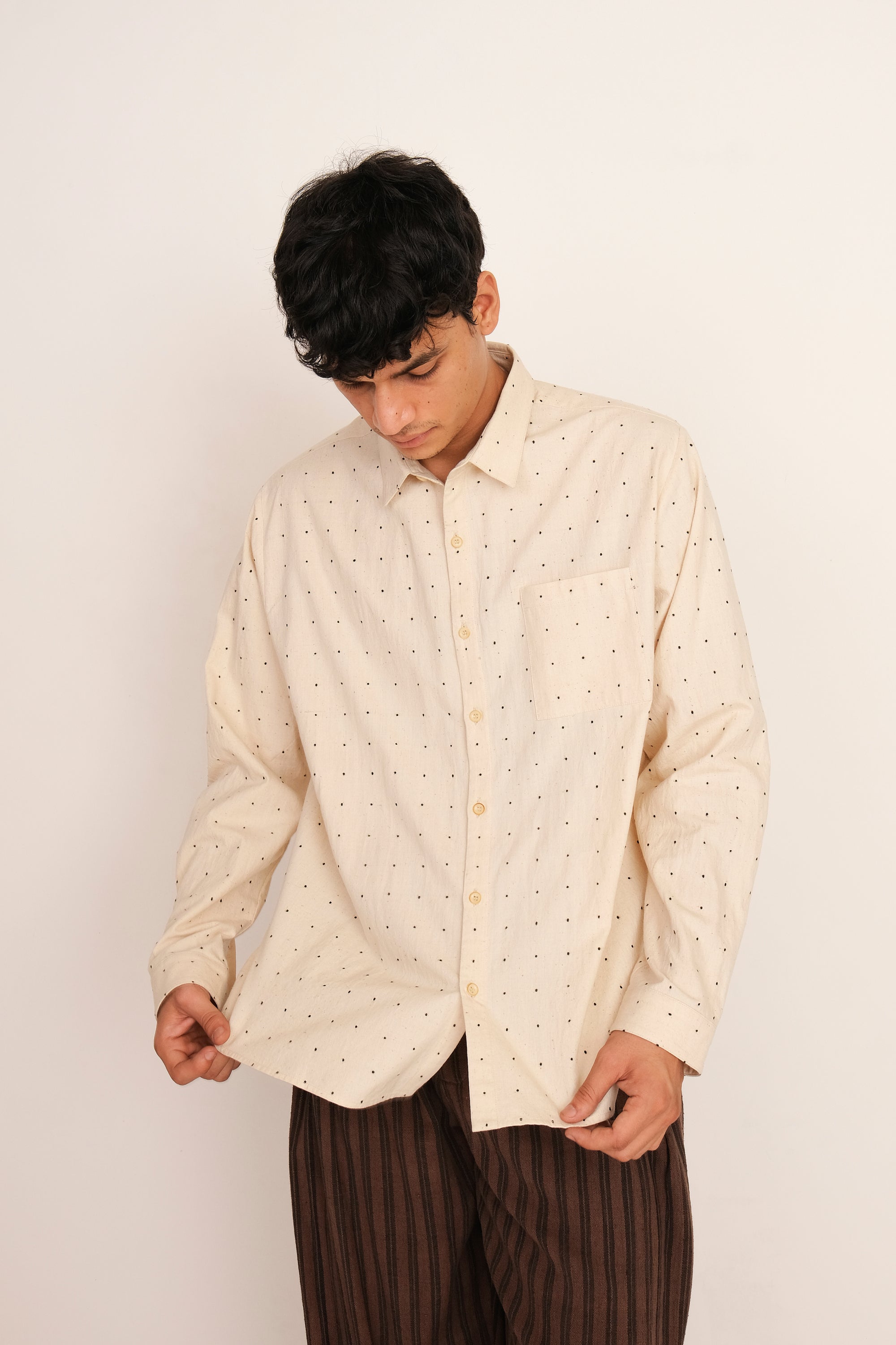 A man wearing ecru cotton shirt