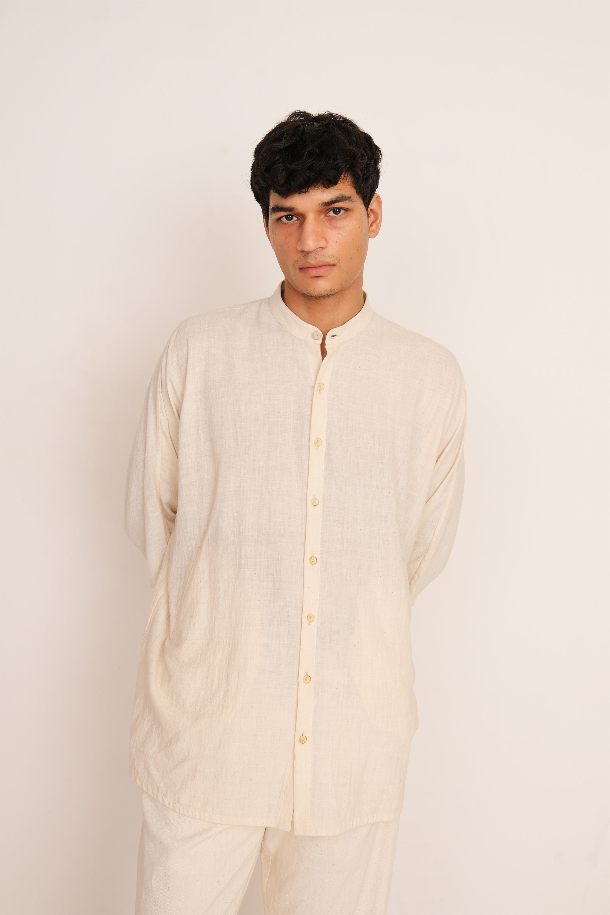 A man wearing ecru cotton shirt