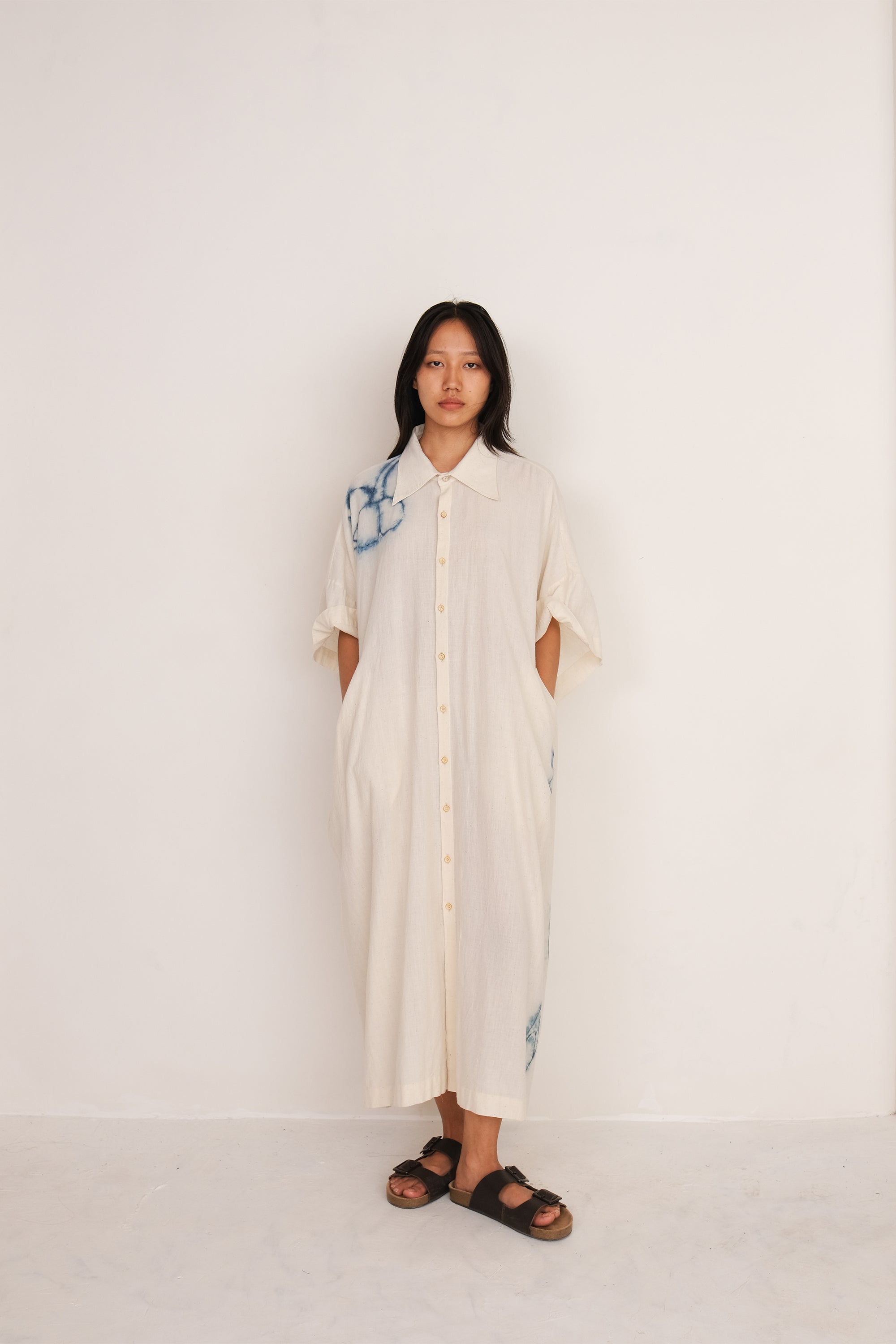 A woman wearing ecru kaftan dress
