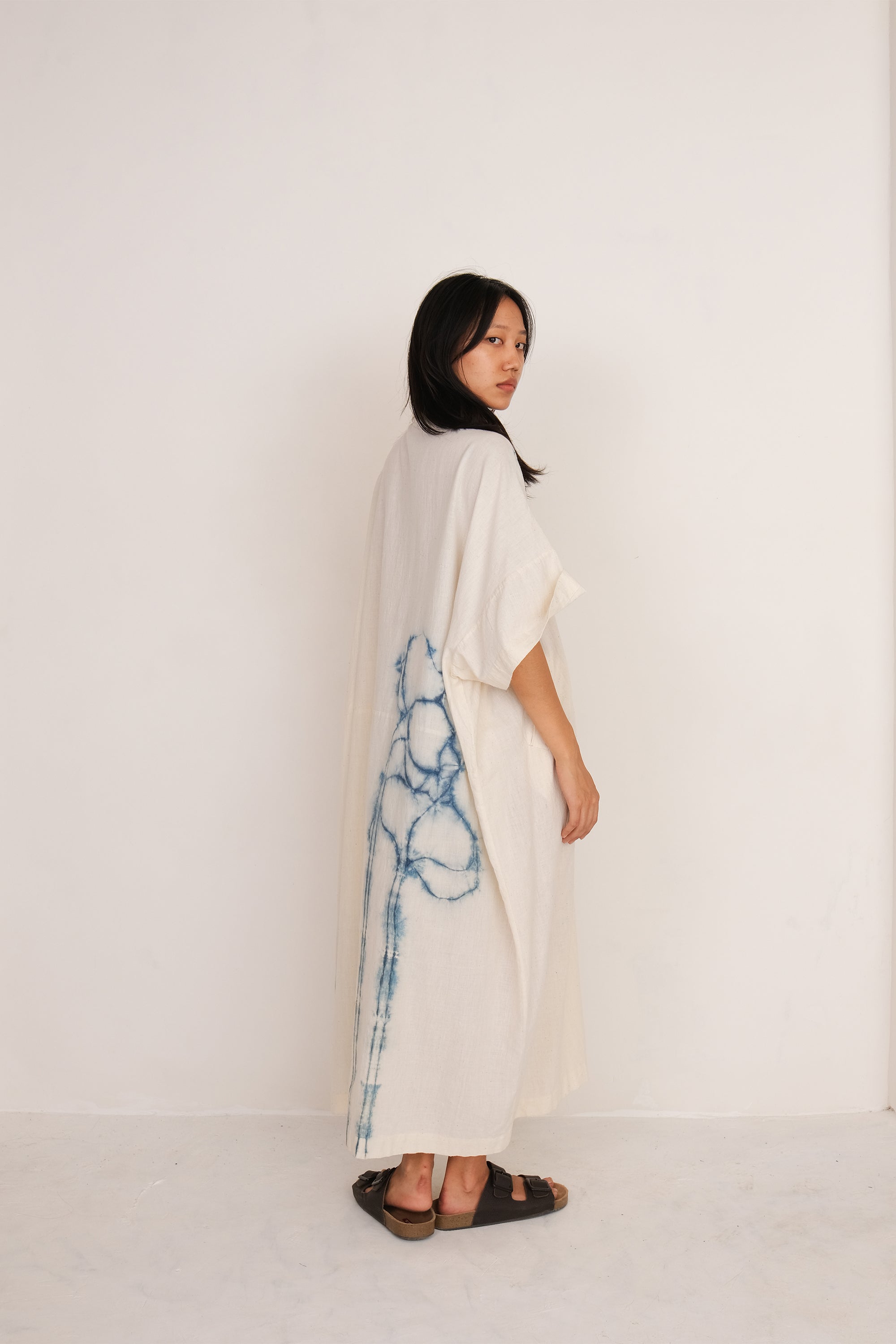 A woman wearing ecru shibori kaftan
