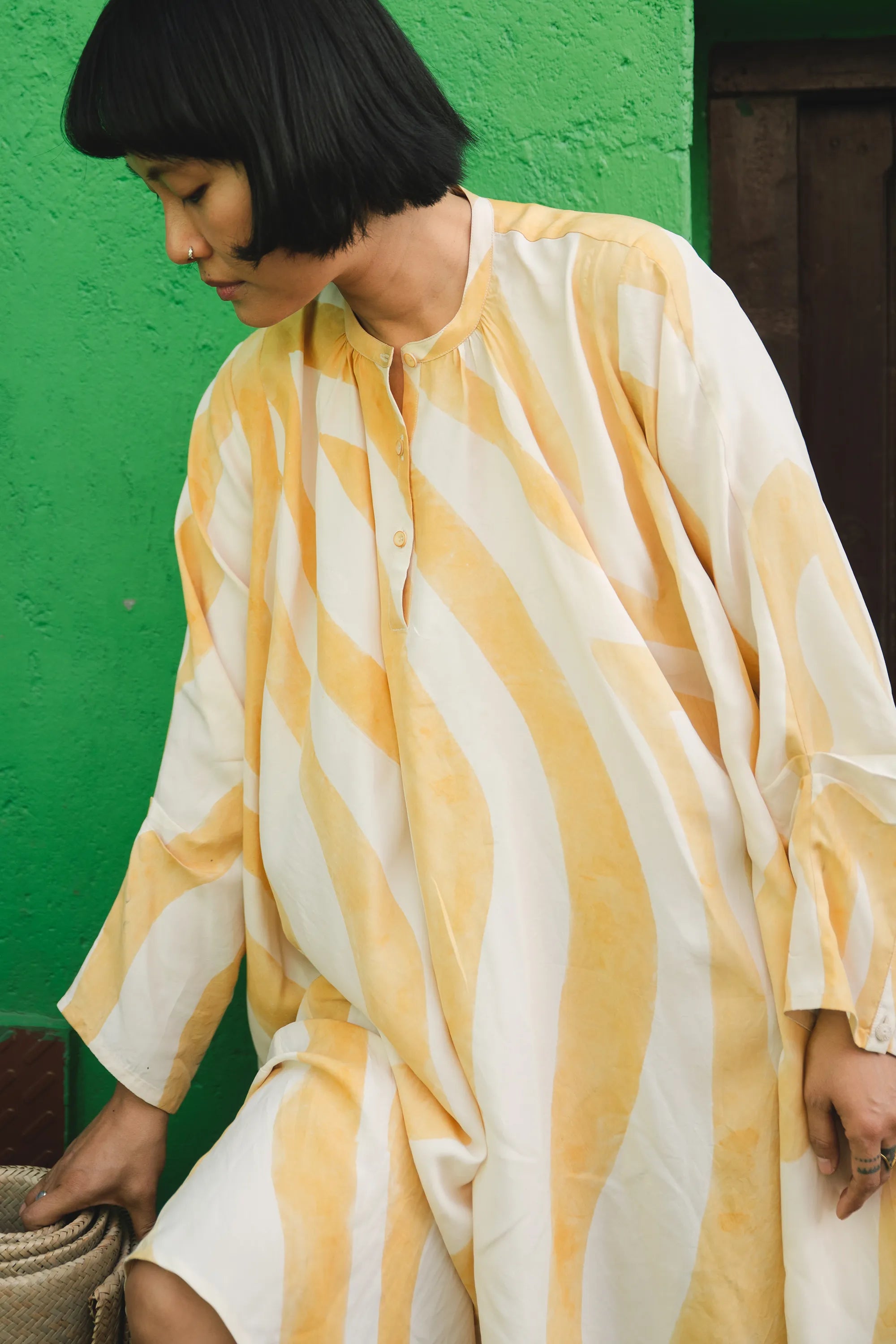 A side shot of women wearing mango yellow silk dress